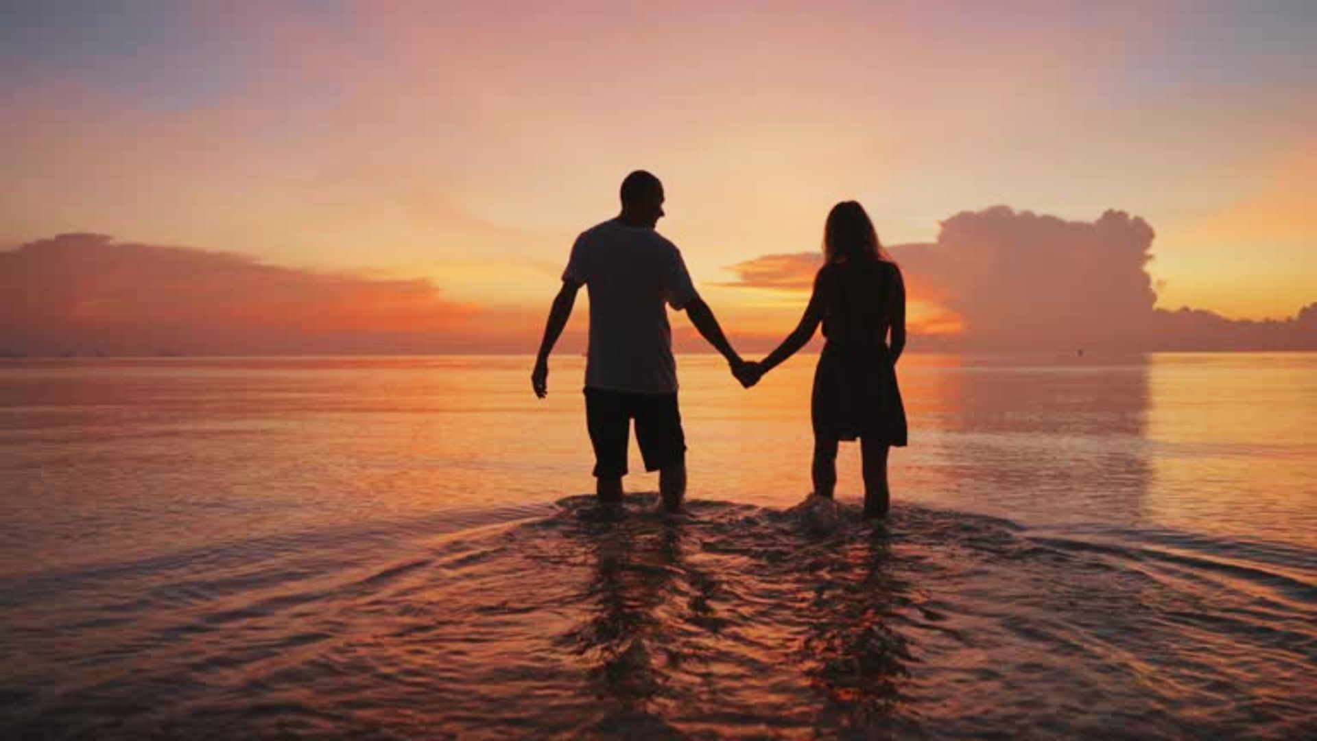 couple enjoying the walk on the beach.