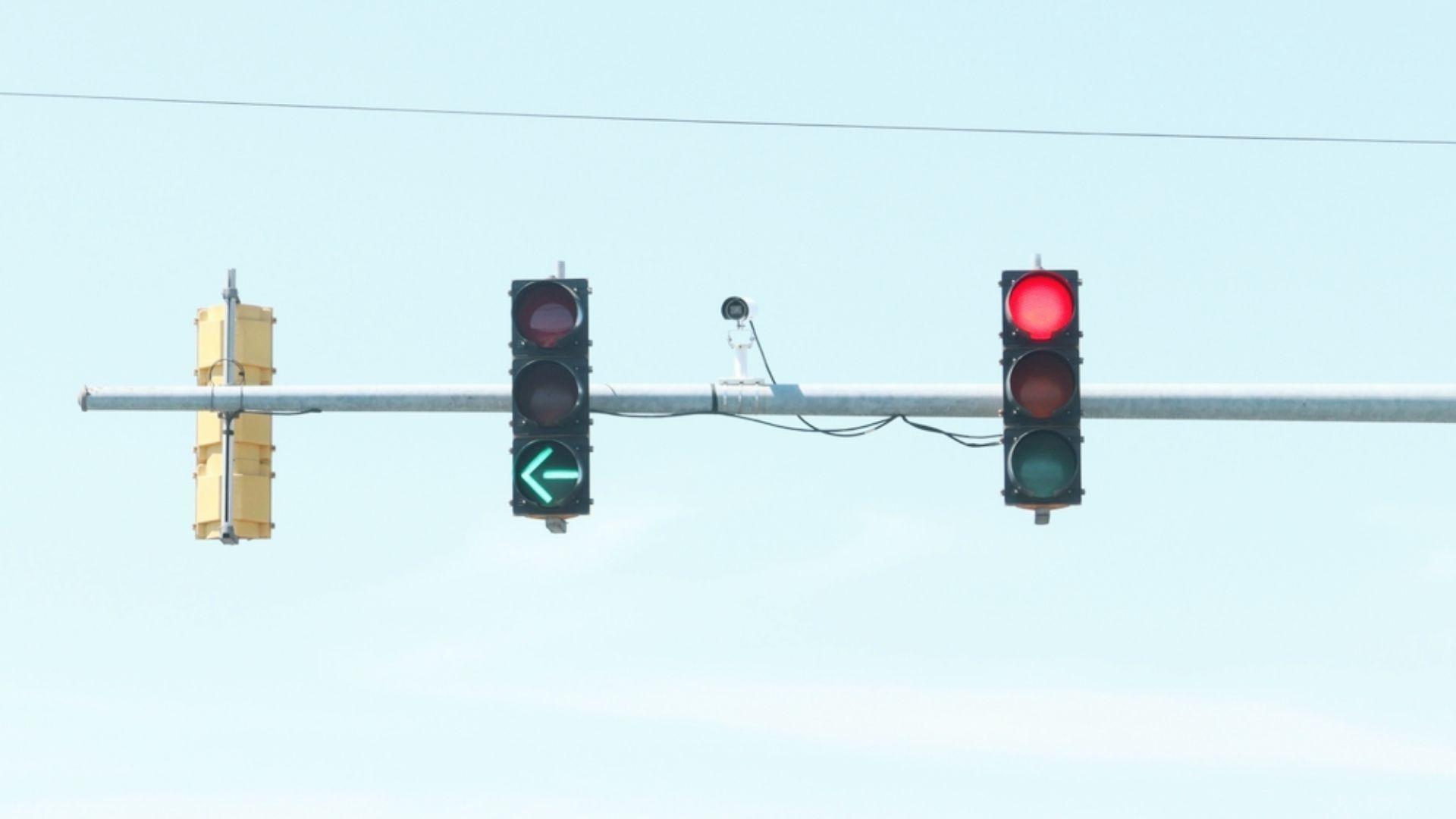 No left turn traffic sign mounted beside traffic light at intersection showing Georgia driving laws for prohibited turns