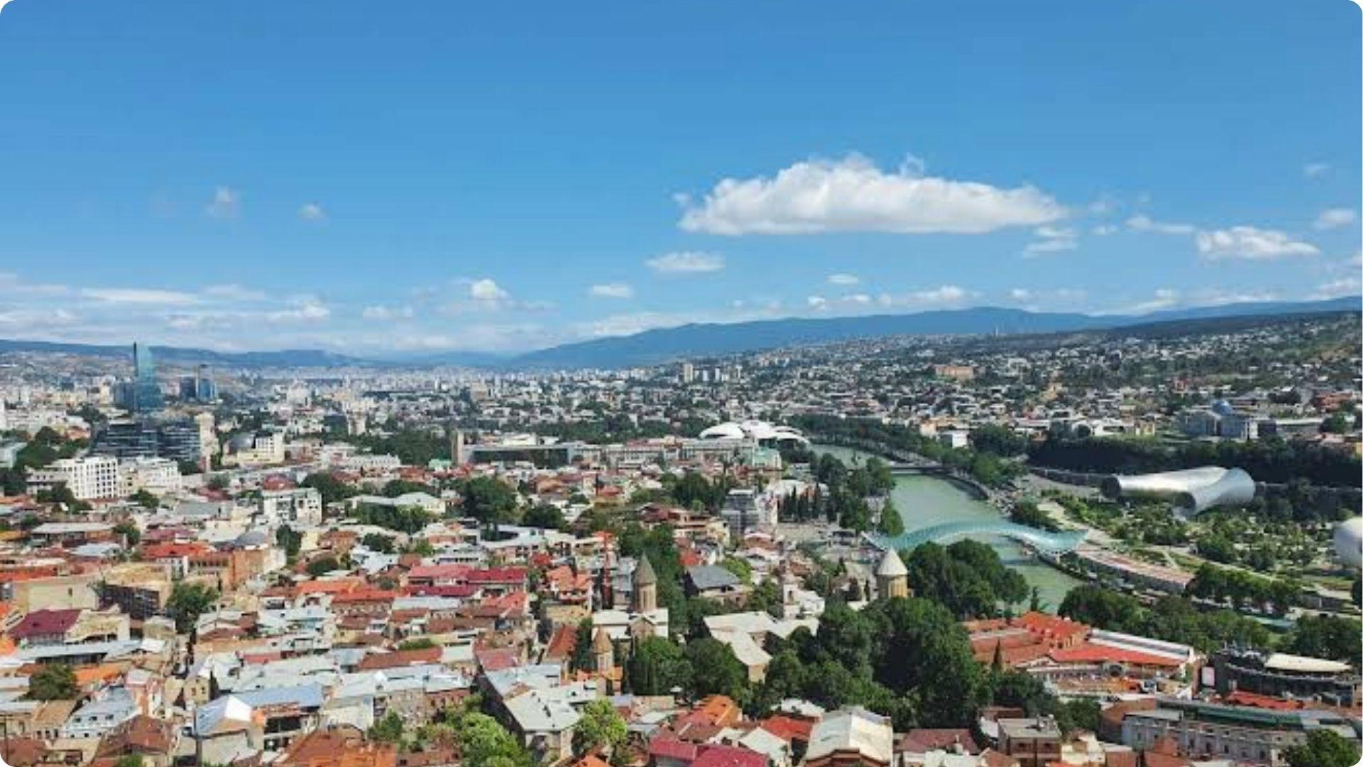 Panoramic view of Georgia's coastal historic district with terracotta rooftops and ancient fort overlooking the city.