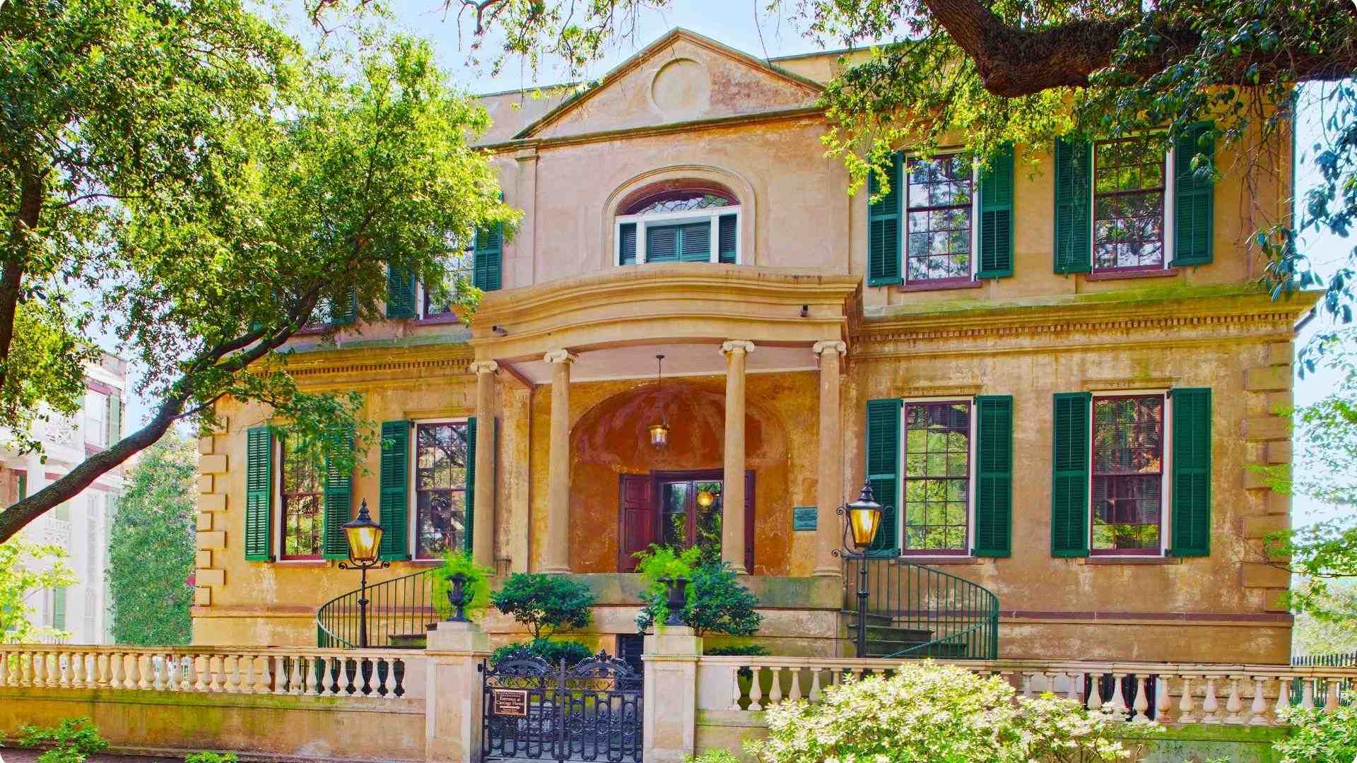 Historic Owens-Thomas House in Savannah featuring vintage columns, green shutters.