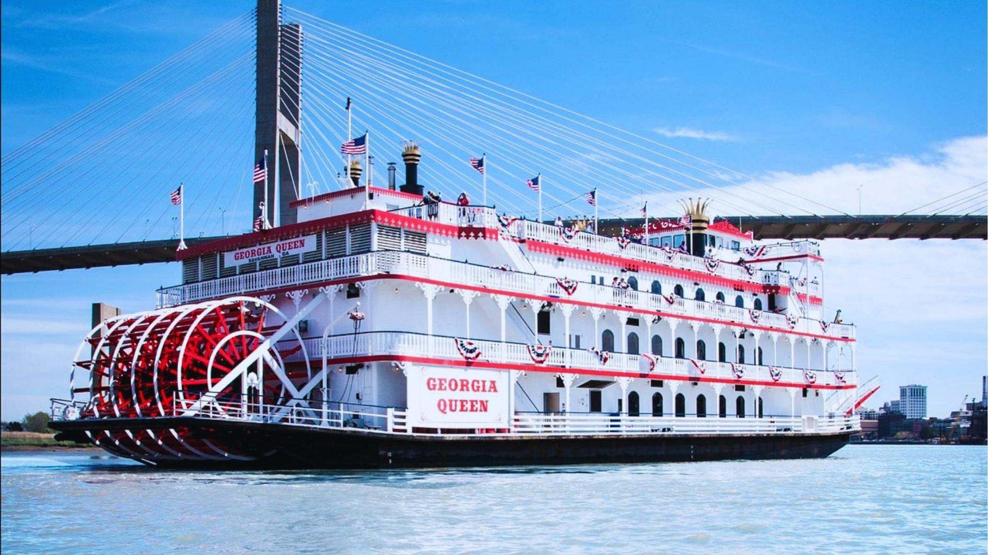 Georgia Queen riverboat cruising under Talmadge Memorial Bridge on Savannah River.