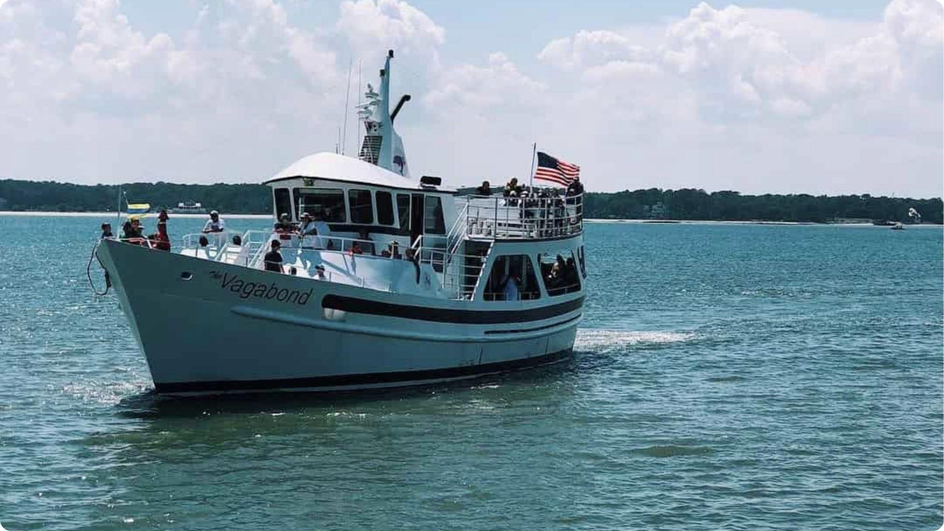 Crowded Vagabond ferry transporting tourists to Daufuskie Island on a sunny day over blue water