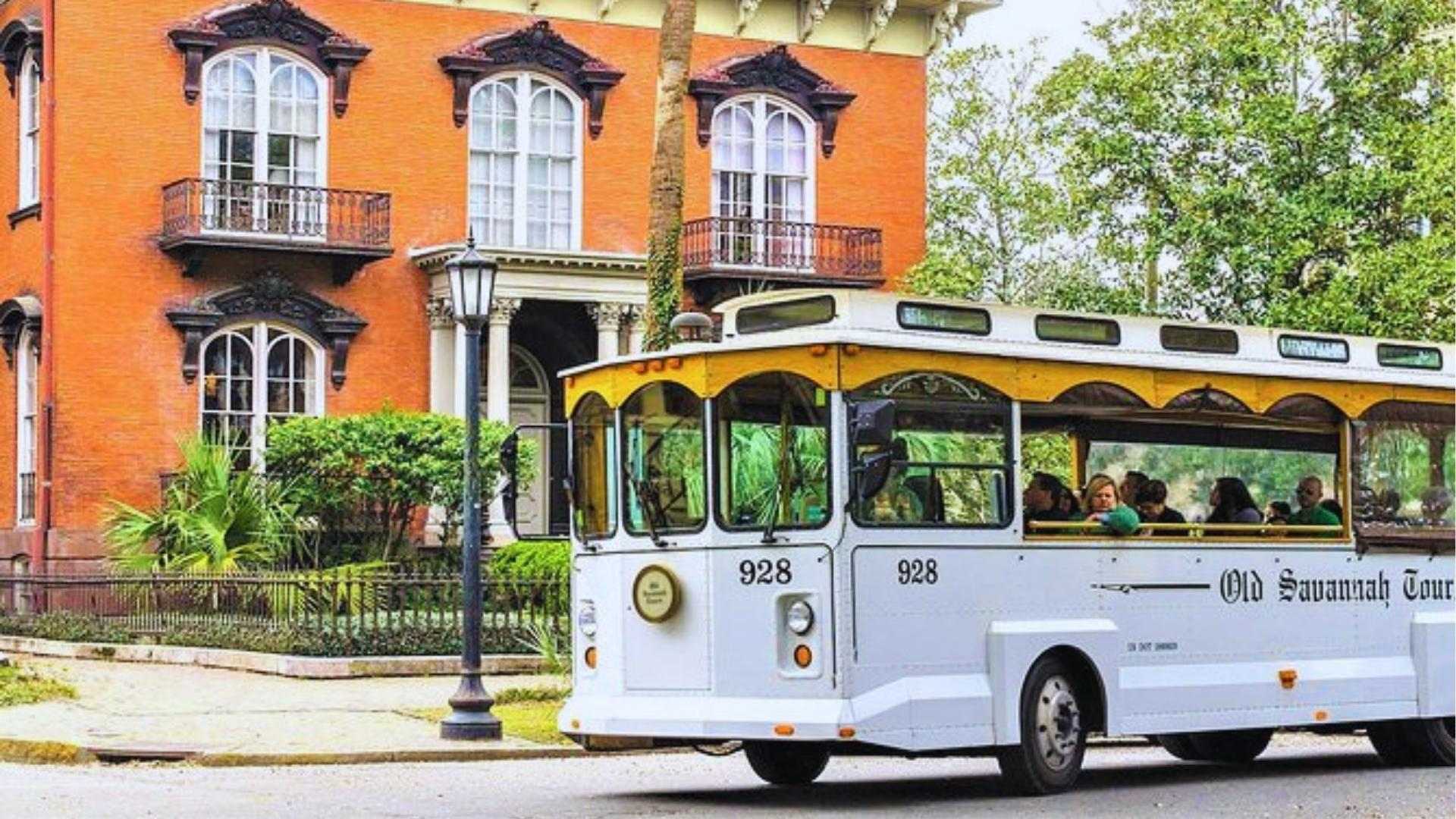 Old Savannah Trolley Tour 928 passing the Mercer Williams House in Savannah Historic District.