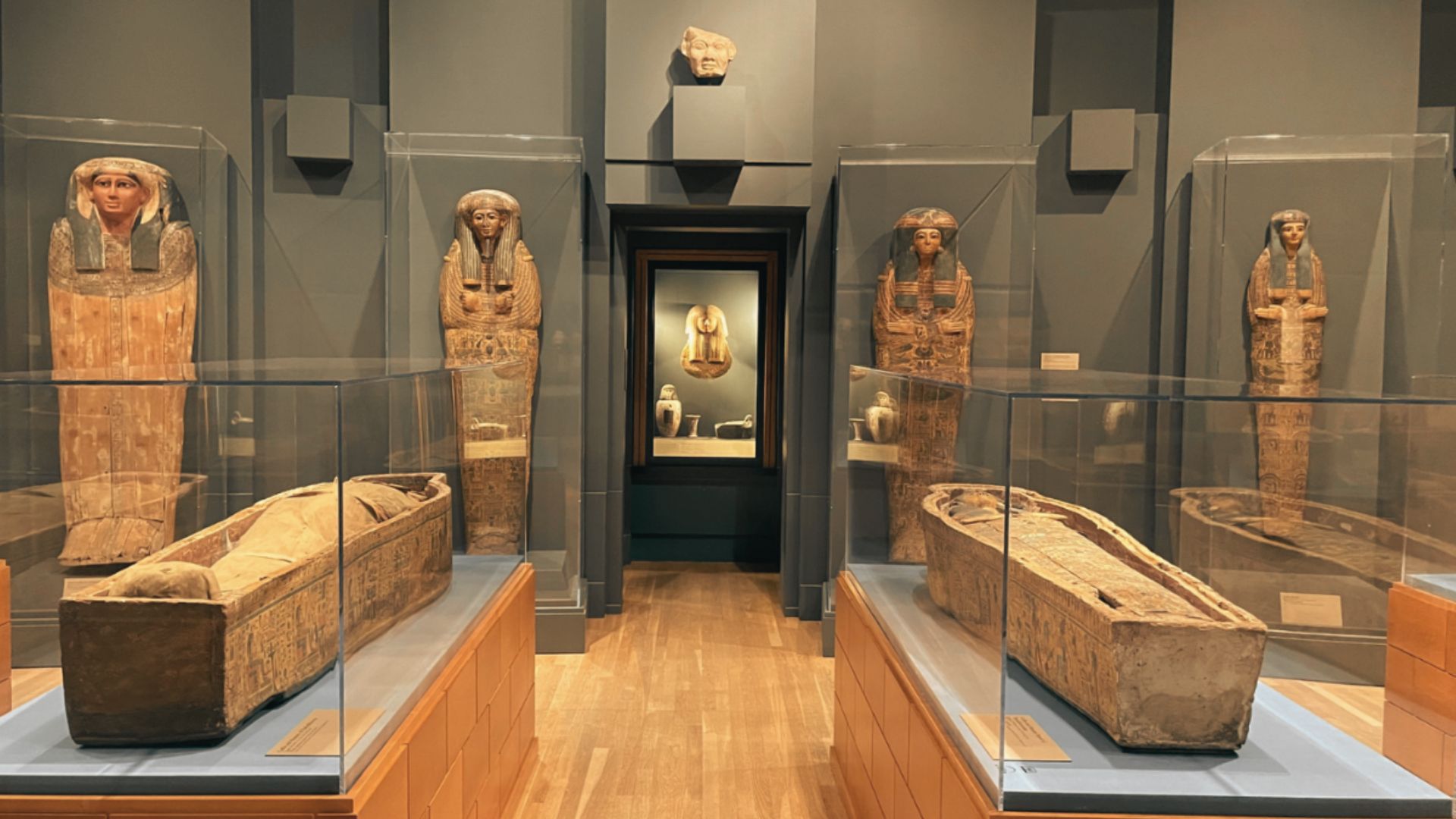 Ancient Egyptian sarcophagi and artifacts displayed inside Michael C. Carlos Museum at Emory University.