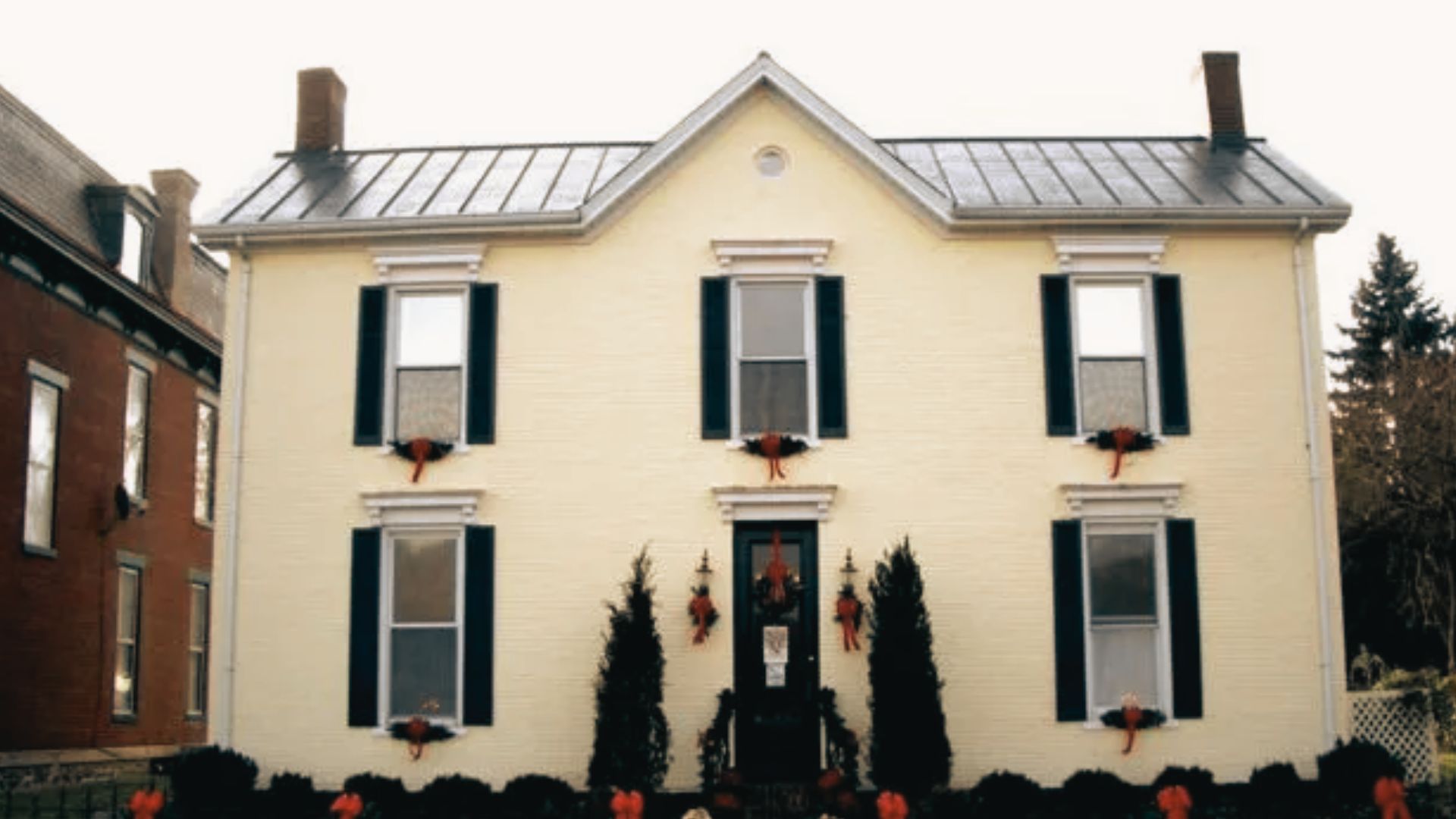 Rosemary Clooney House and Museum featuring a cream brick facade with black shutters and flower boxes.