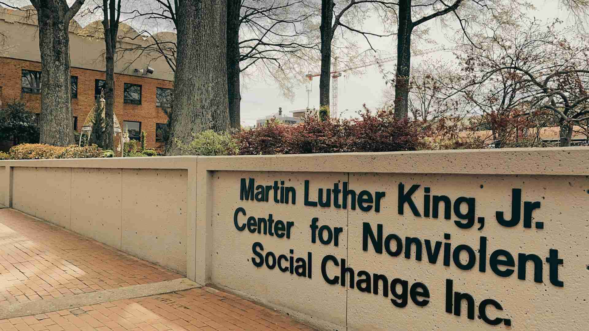 Martin Luther King Jr Center for Nonviolent Social Change entrance sign beside landscaped brick walkway.