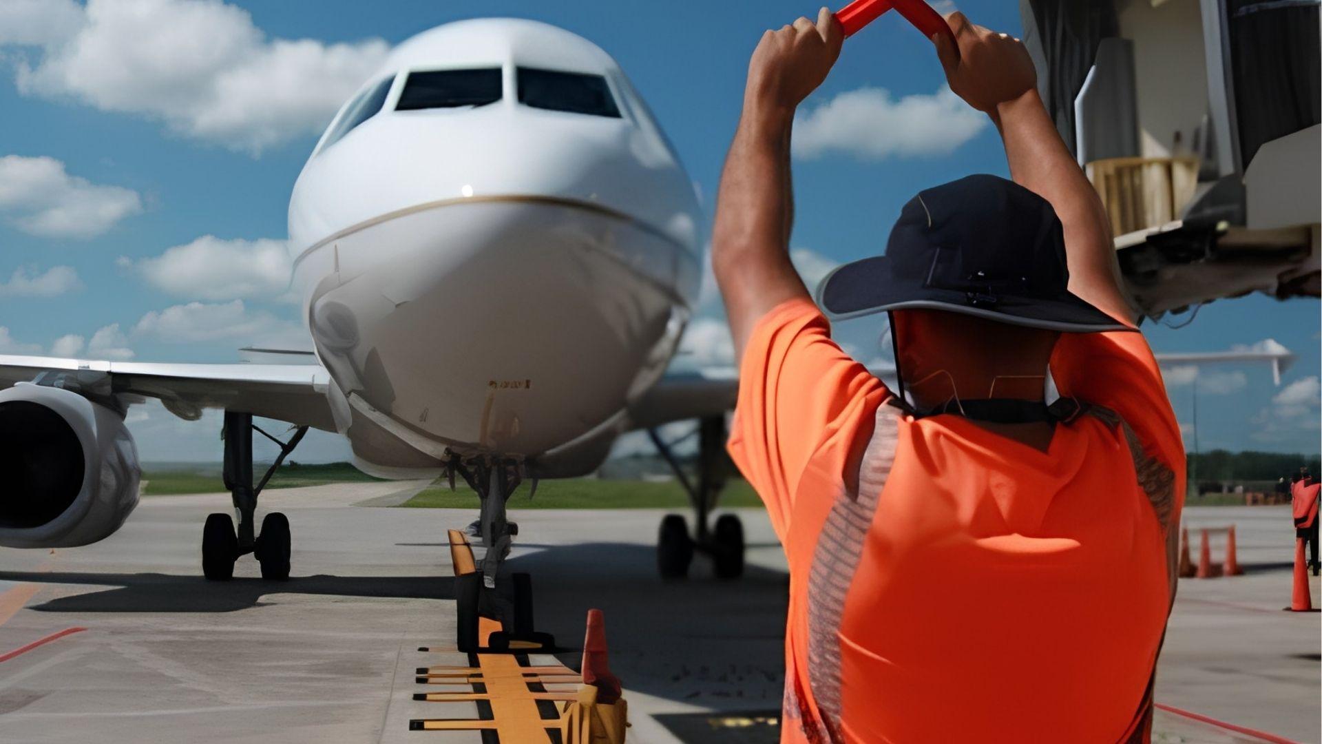 A man showing Cross Sign to a plane ready for takeoff.