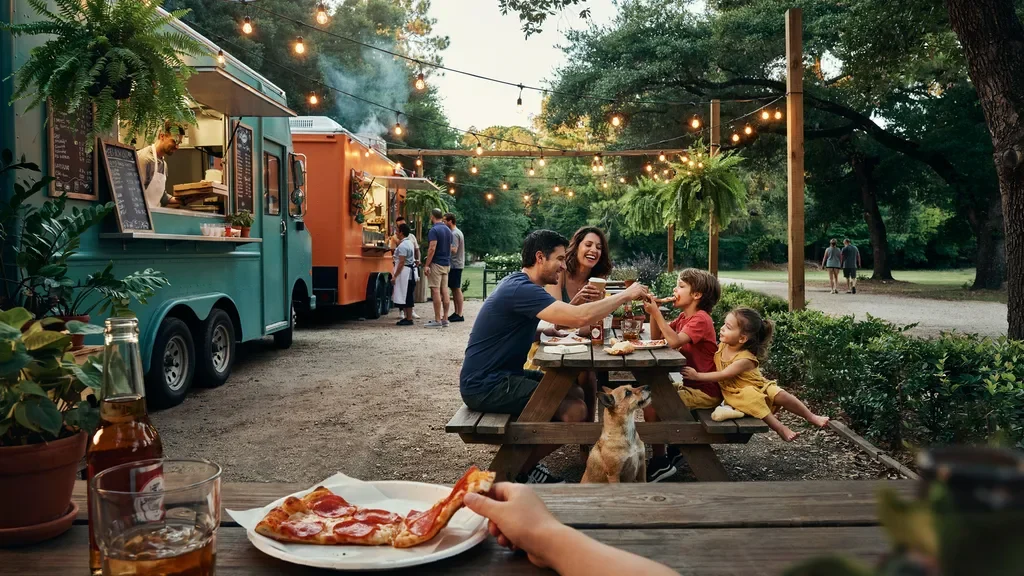 Outdoor dining area at Starland Yard with food trucks and seating.