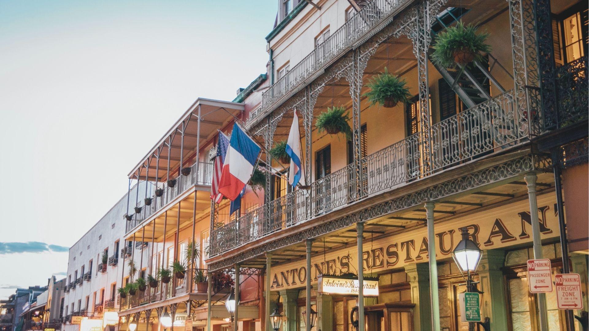 Admire iconic French Quarter architecture with hanging ferns, French flags, and intricate iron balconies.