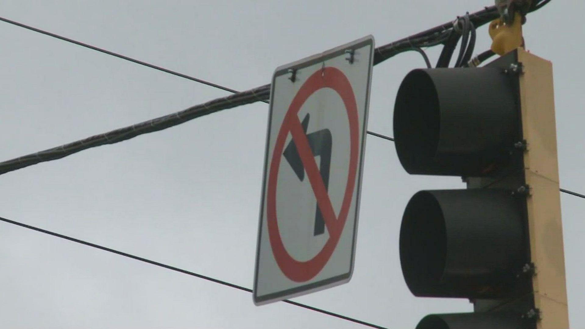 Close-up of illuminated red traffic signal on yellow light housing showing when Georgia drivers must stop before turning