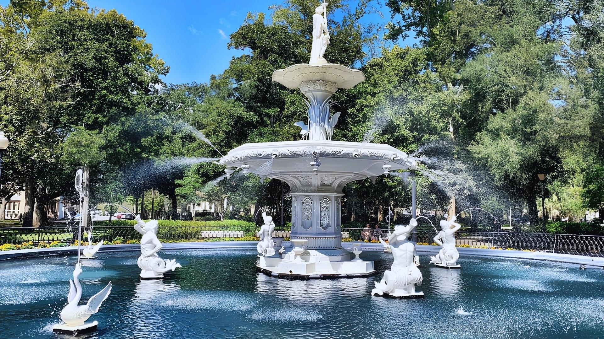 Forsyth Park's white fountain with swan statues sparkling on a sunny day in Savannah.