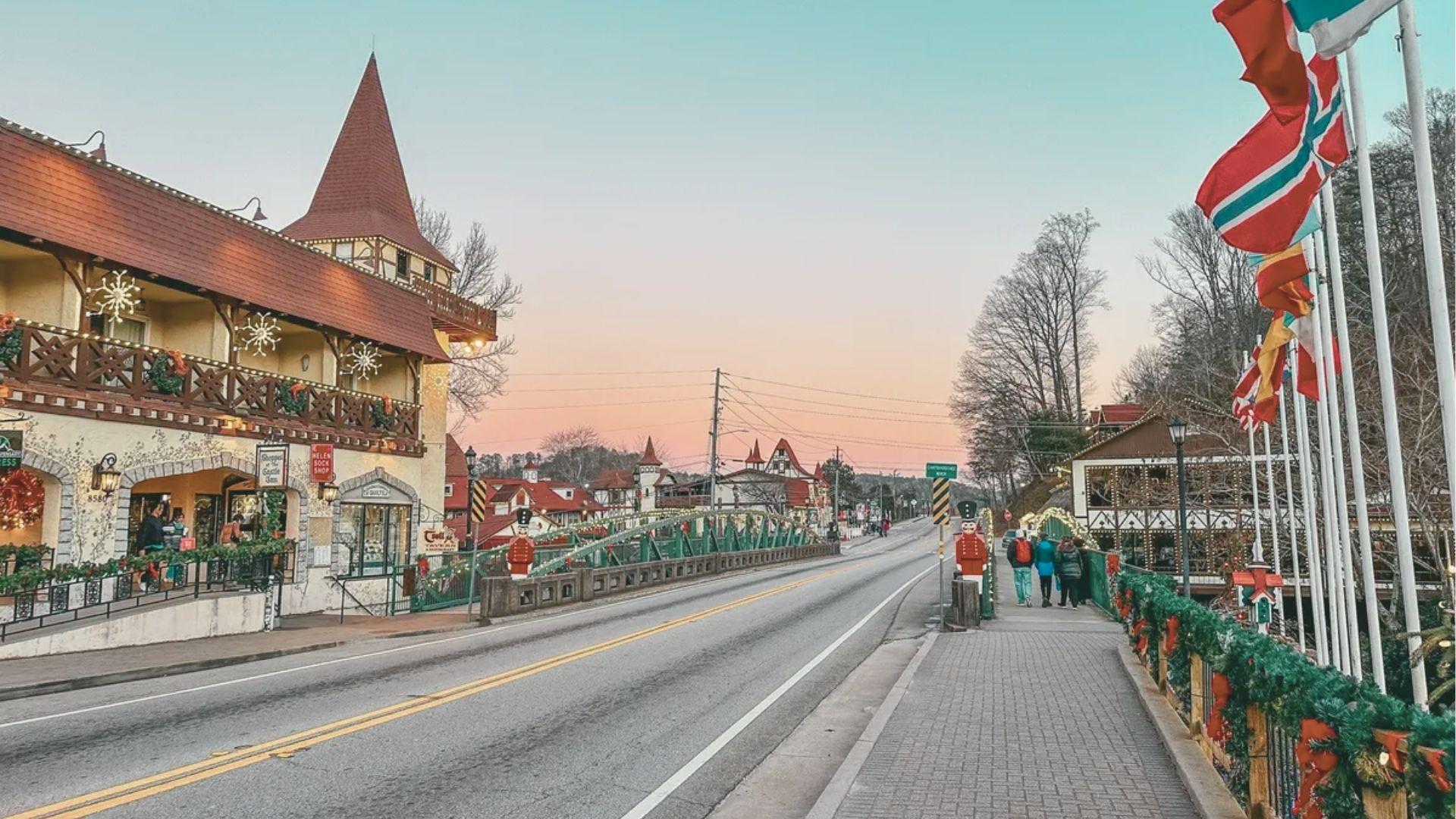 Sunset over Helen’s main bridge decorated with garland, red bows, and nutcracker statues.