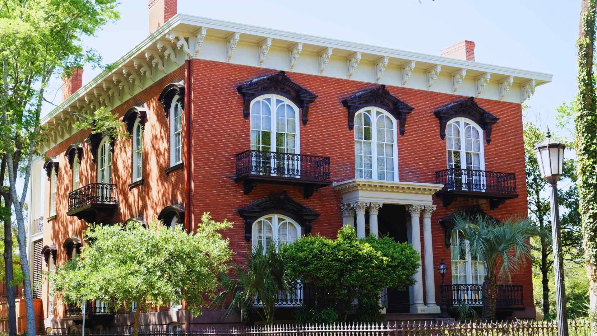 Historic Mercer-Williams House red brick mansion with iron balconies in Savannah Historic District.