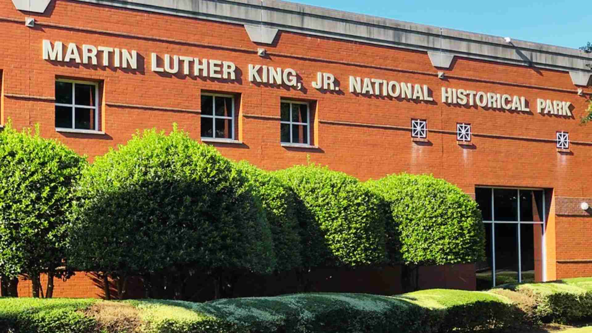 Martin Luther King Jr. National Historical Park visitor center building stands behind neatly trimmed green hedges.