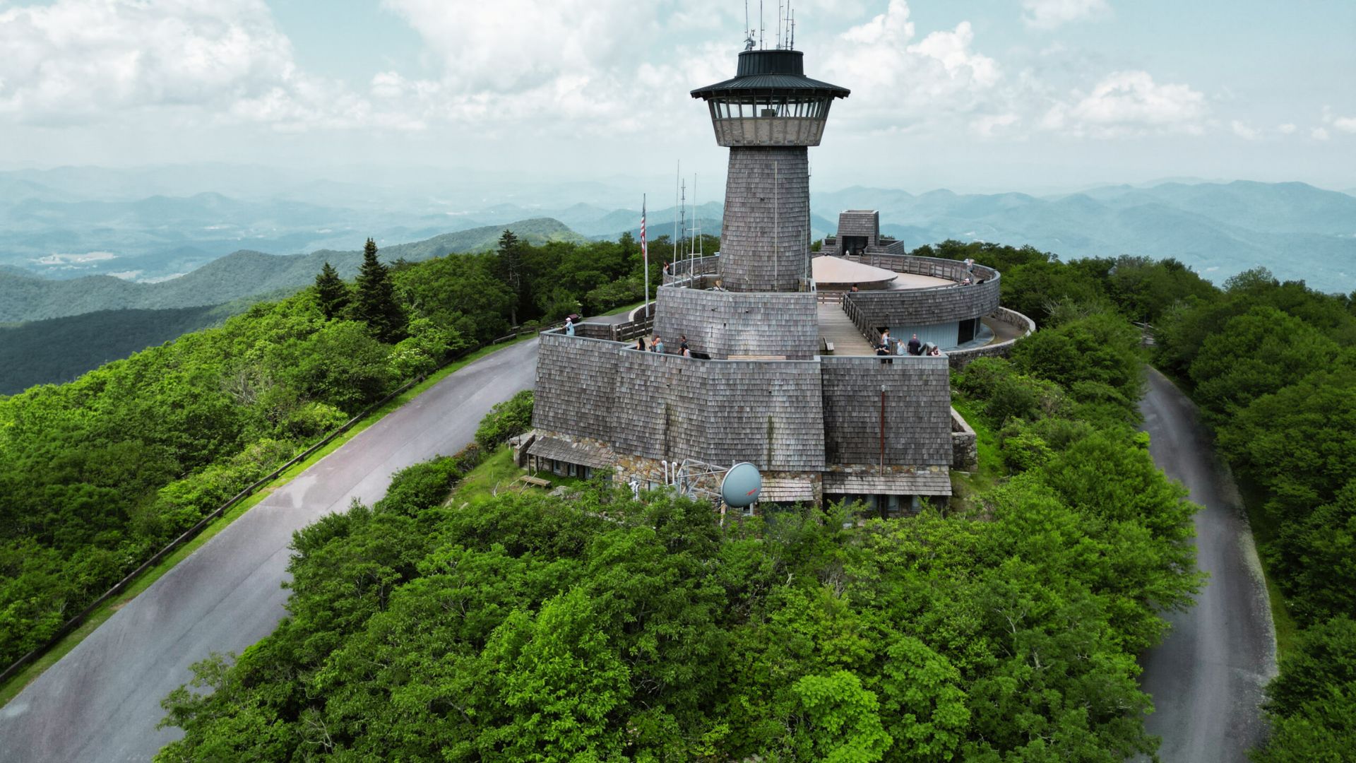 Brasstown Bald Summit Trail observation tower above green forests with winding roads and distant mountain views.