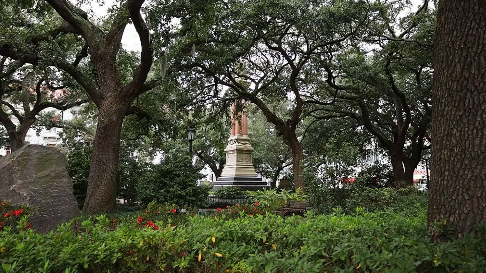Monument to William Washington Gordon with red columns under live oaks in Wright Square, Savannah.