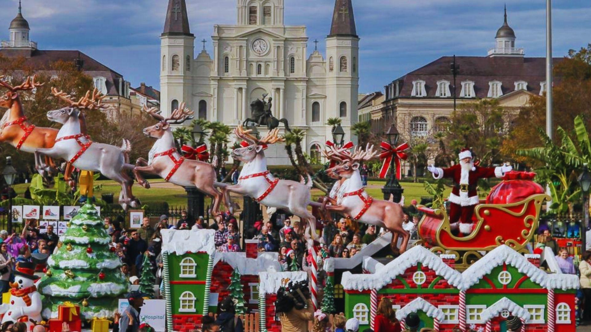 Santa’s sleigh and reindeer parade float with snow-covered houses, Christmas tree, St. Louis Cathedral and crowds behind