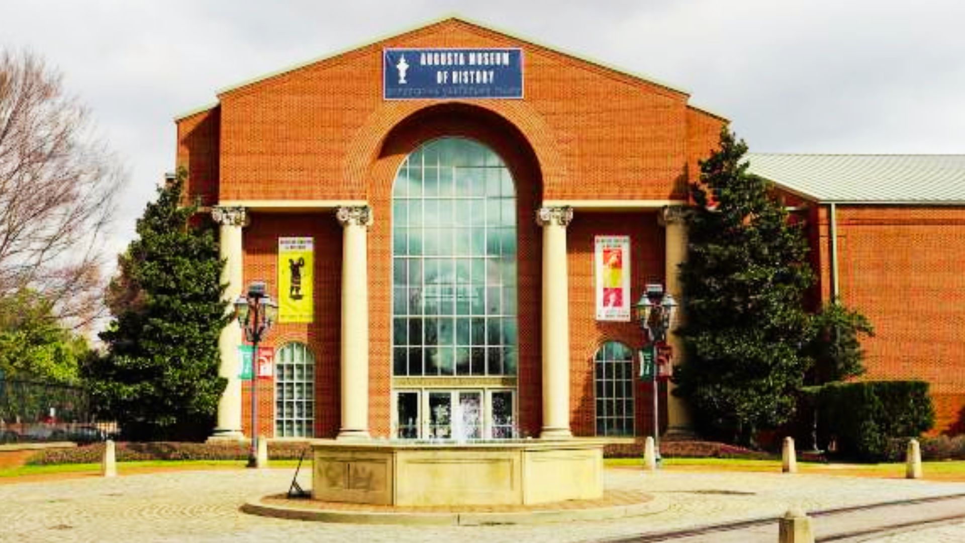 Augusta Museum of History building with tall columns and large arched glass entrance facade.