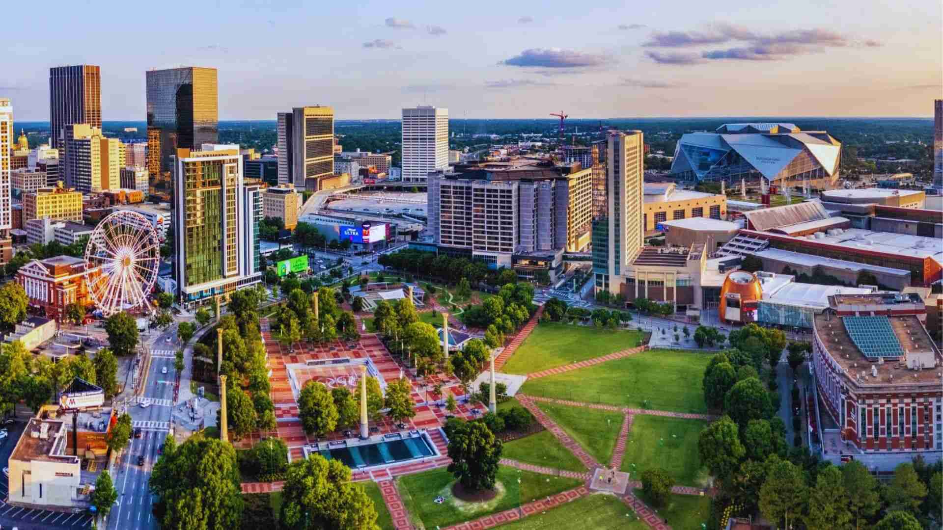 Aerial view of Centennial Olympic Park and downtown Atlanta skyline with SkyView Atlanta Ferris wheel.