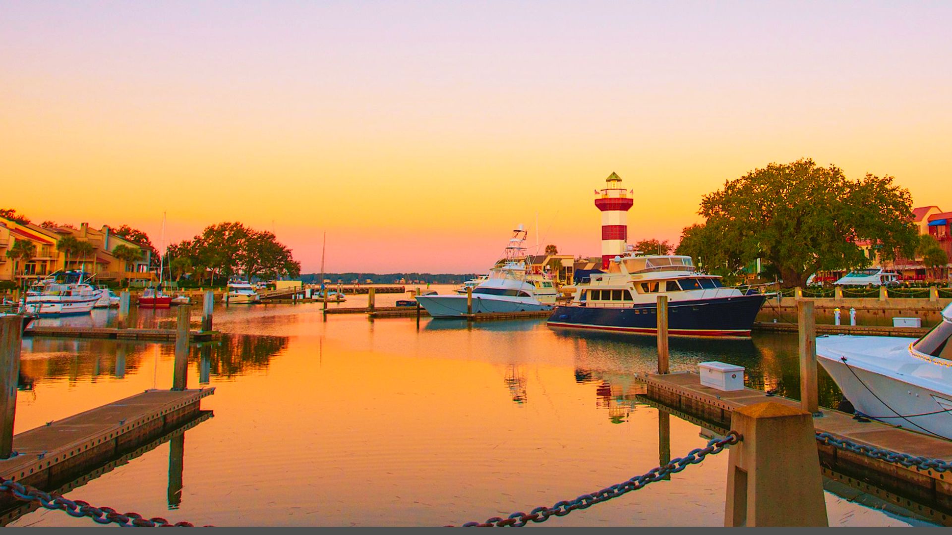 Summer beach scene on Hilton Head Island and lighthouse under a sunny sky.