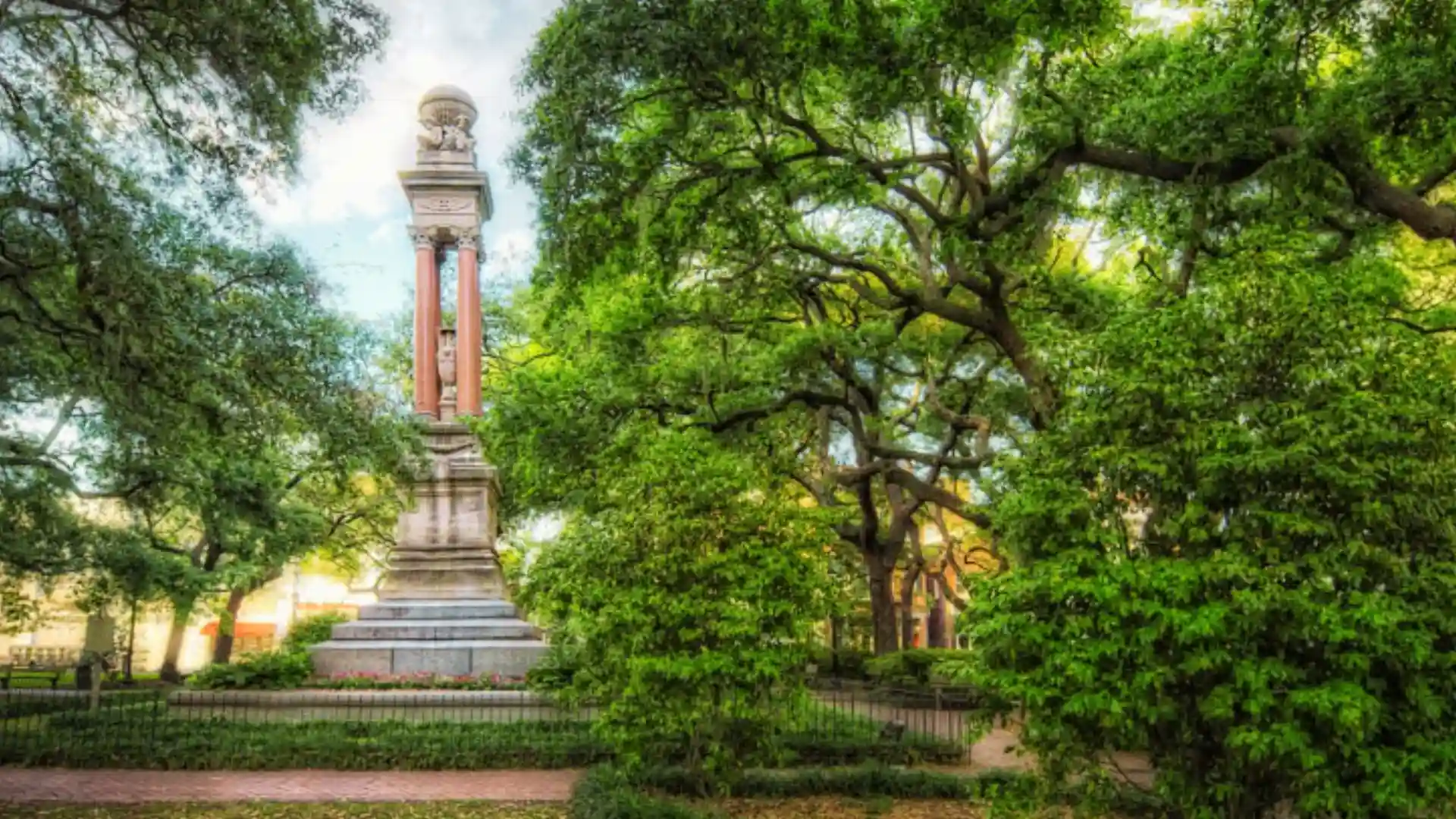 Monument to William Washington Gordon with red columns under live oaks in Wright Square, Savannah.