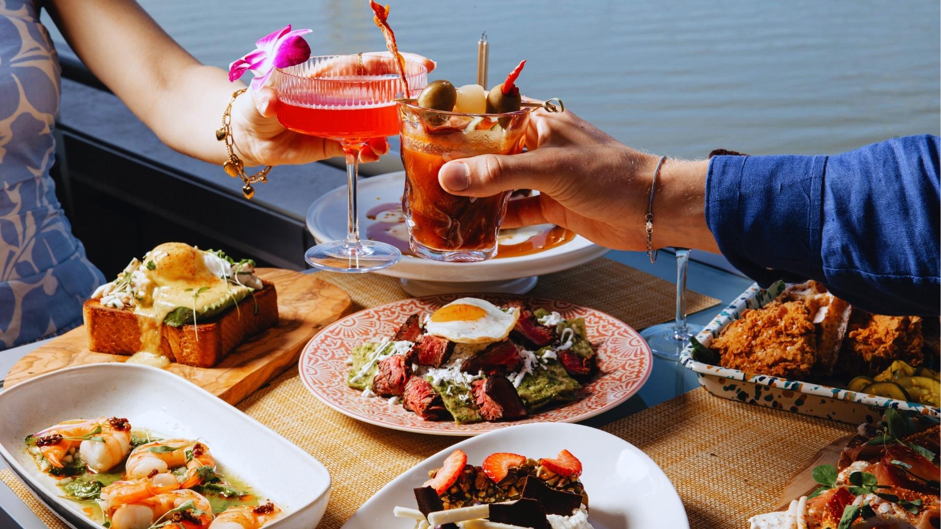 Brunch with shrimp, steak and cocktails toasting on a sunny waterfront patio in Savannah.