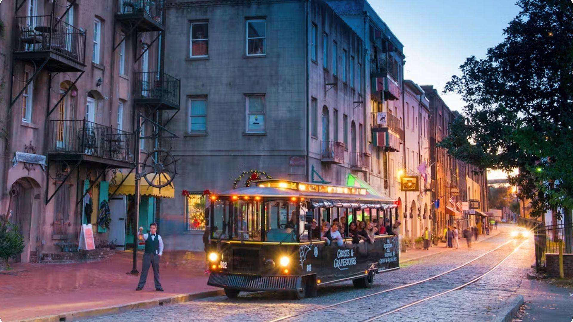 Ghost tour trolley traveling along Savannah’s historic cobblestone streets at dusk.