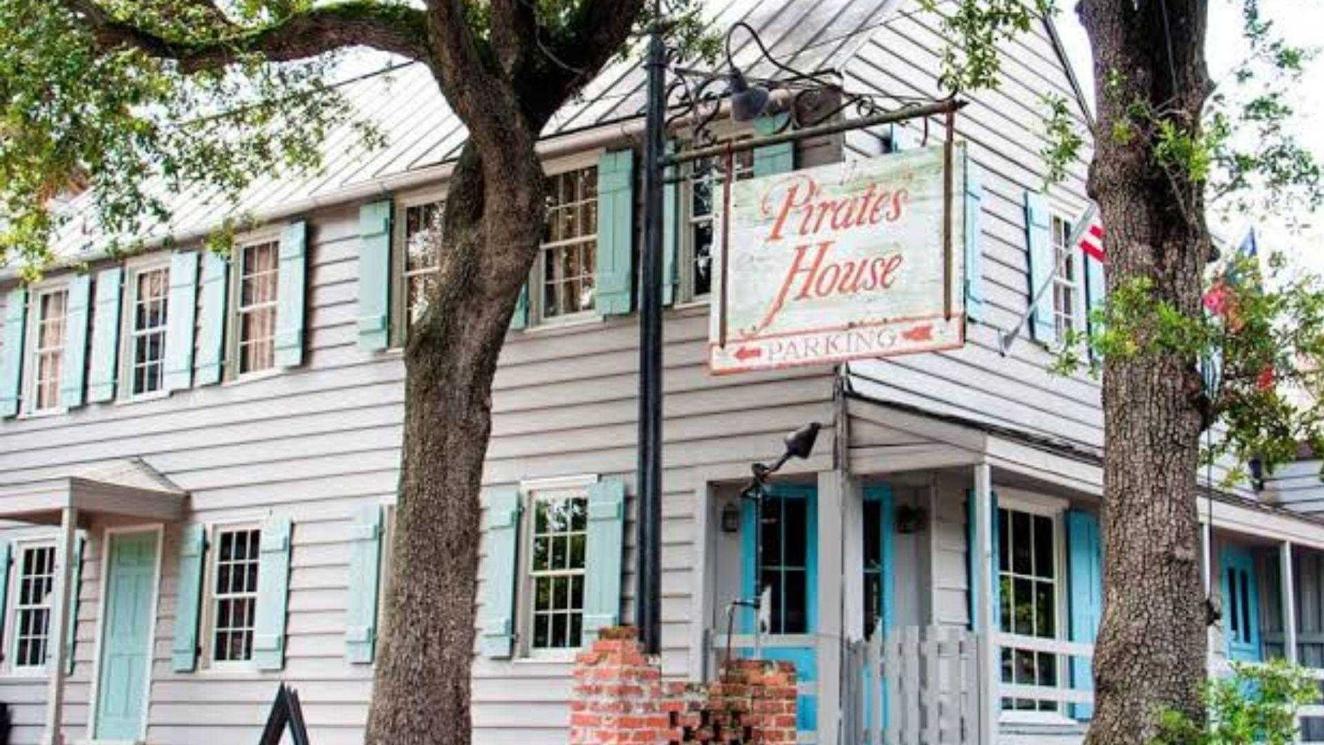 Pirate’s House exterior with grey and turquoise accents and grid windows.