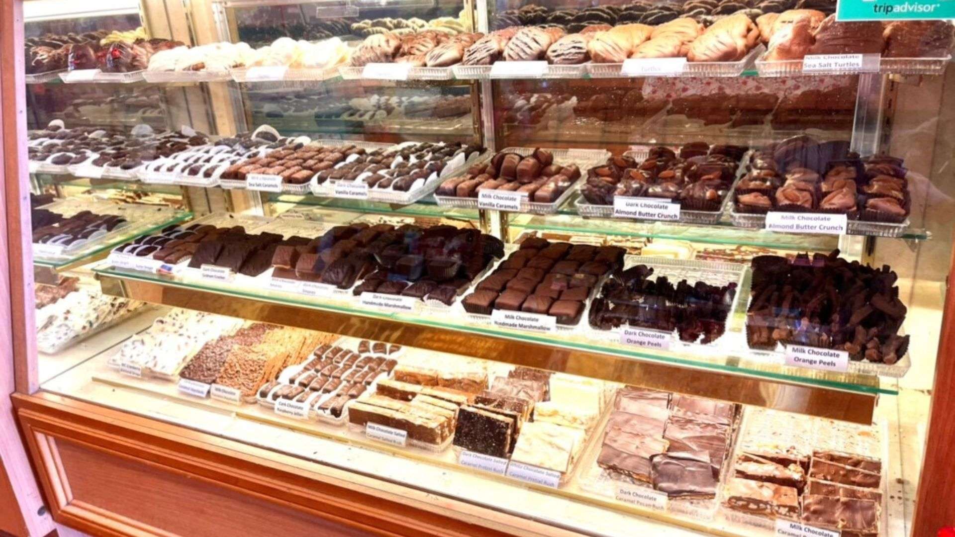 A display case showcasing an assortment of chocolates in various shapes and sizes, highlighting Dahlonega's sweet offerings.