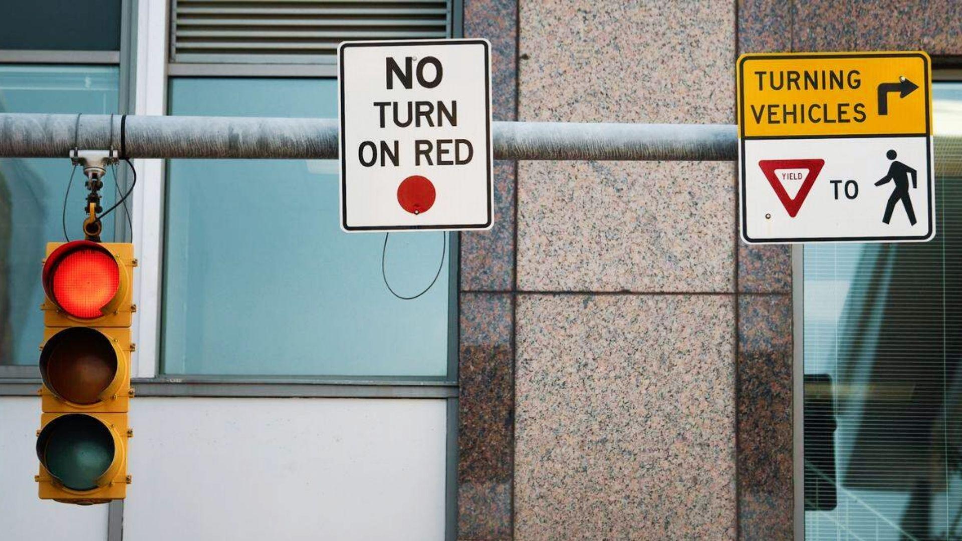 No Turn on Red and Yield to Pedestrians signs with red traffic light explaining Georgia right turn restrictions