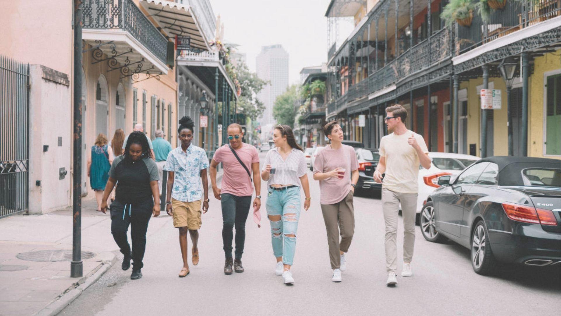 Stroll with friends down a French Quarter street lined with colorful Creole townhouses.