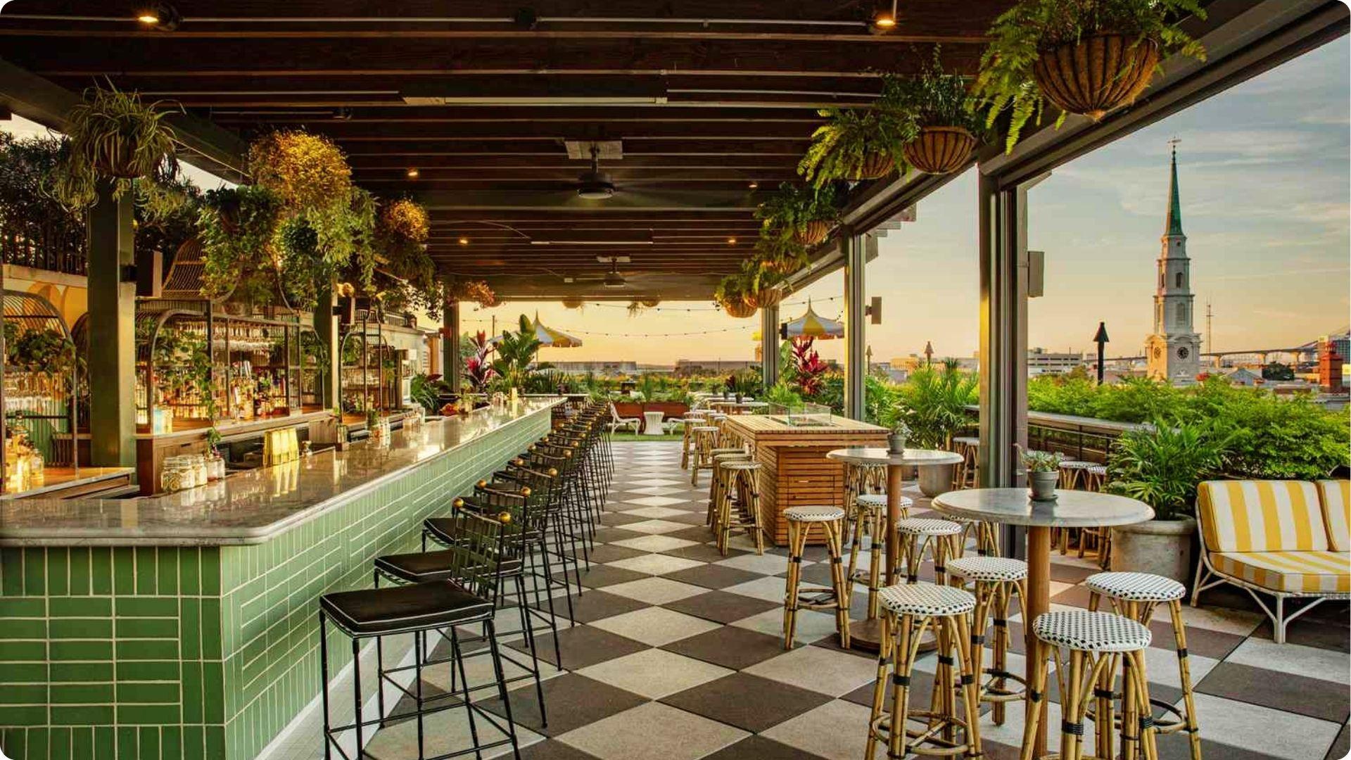 Chic rooftop bar at sunset with lush plants and city views ideal for best dinner savannah ga date night