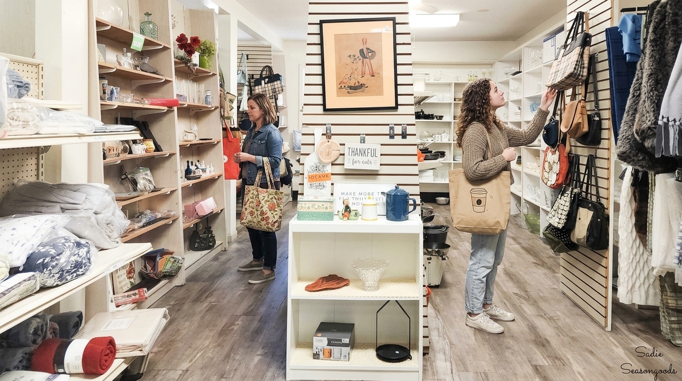 Two women shop Savannah GA thrift stores with handbags, home decor, and floral tote bags.