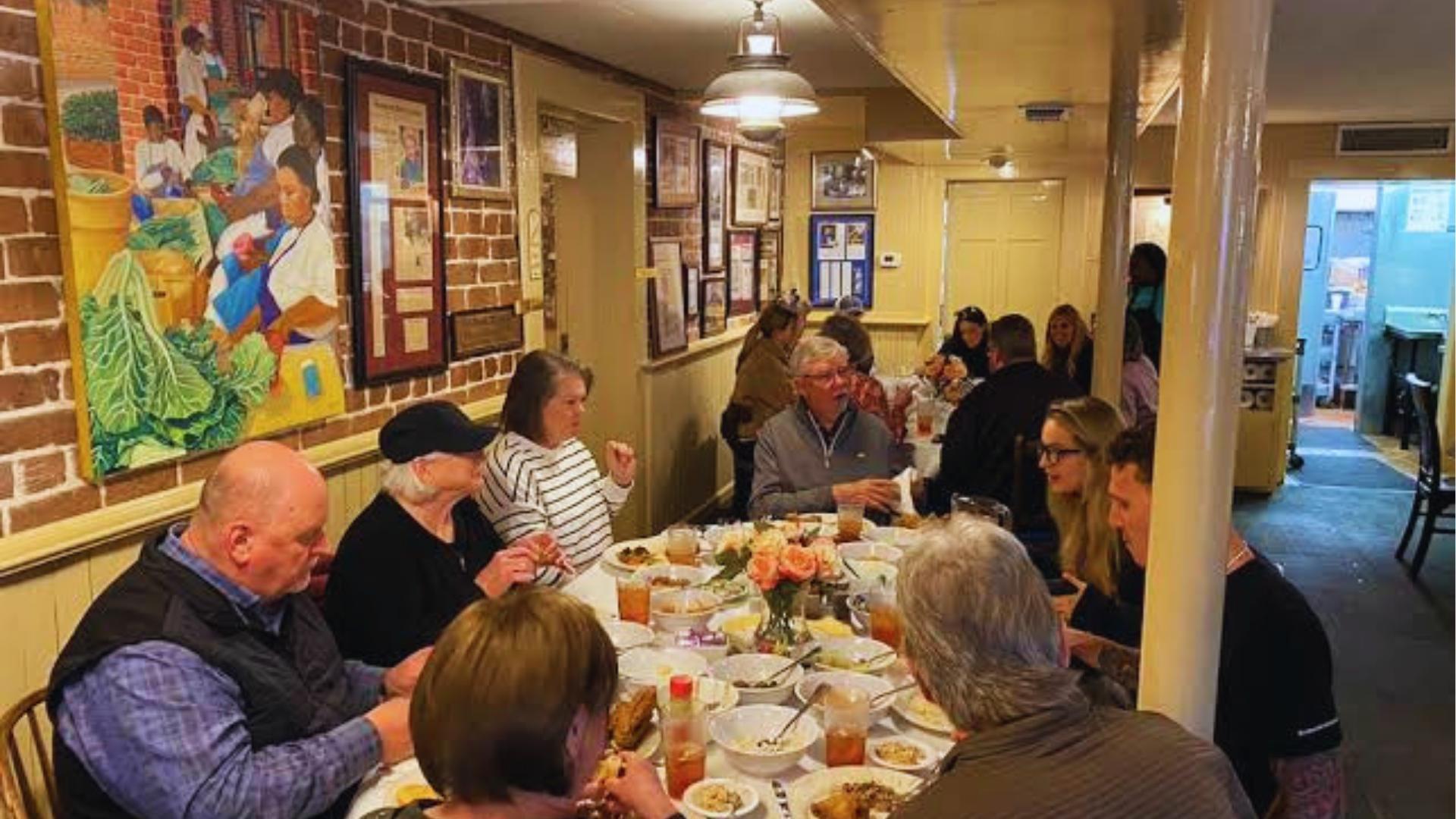 Group enjoying family-style Southern meal at Mrs. Wilkes Dining Room in Savannah, Georgia.