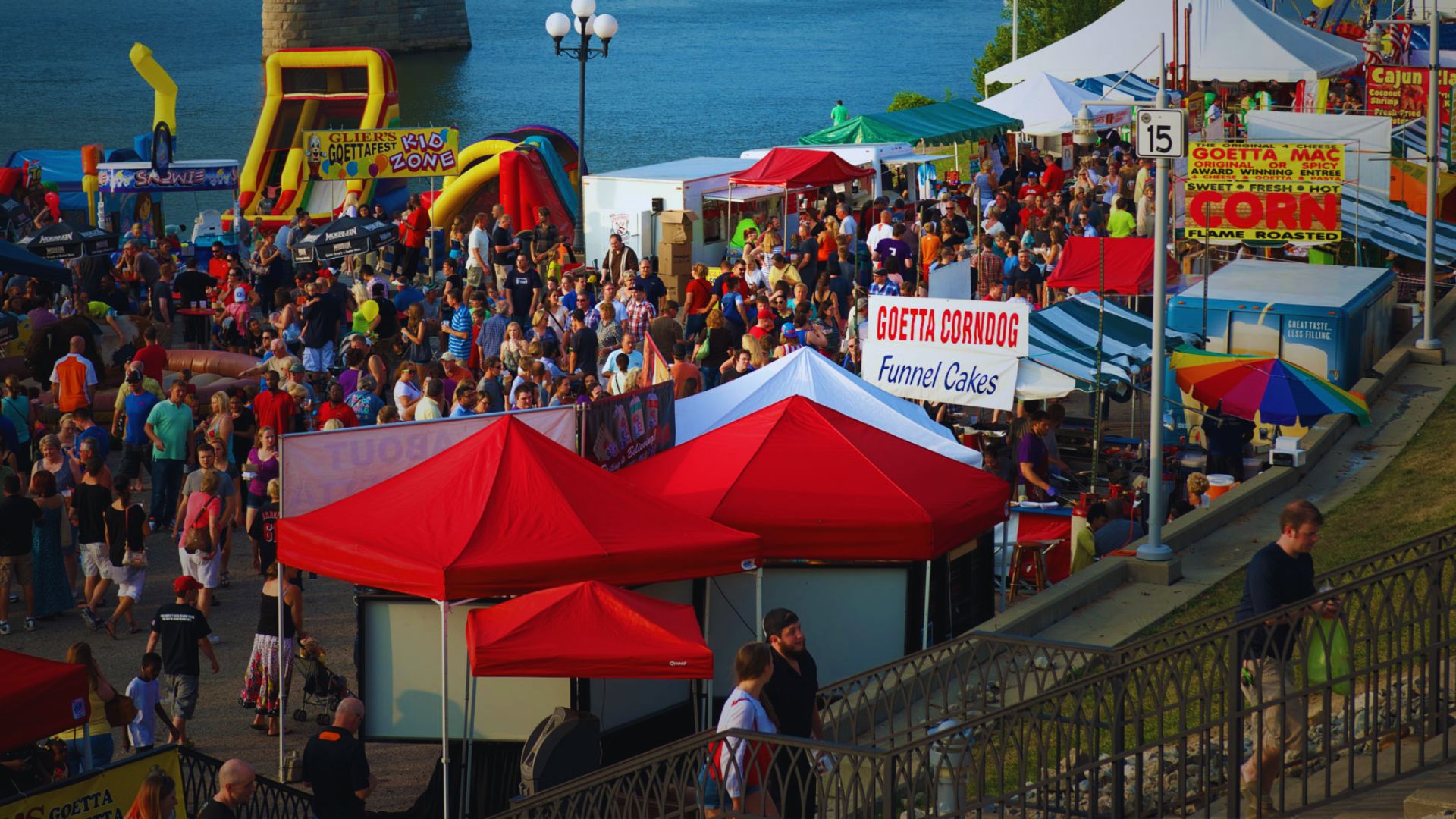 Crowds explore food stalls and entertainment tents during Augusta Riverfest.