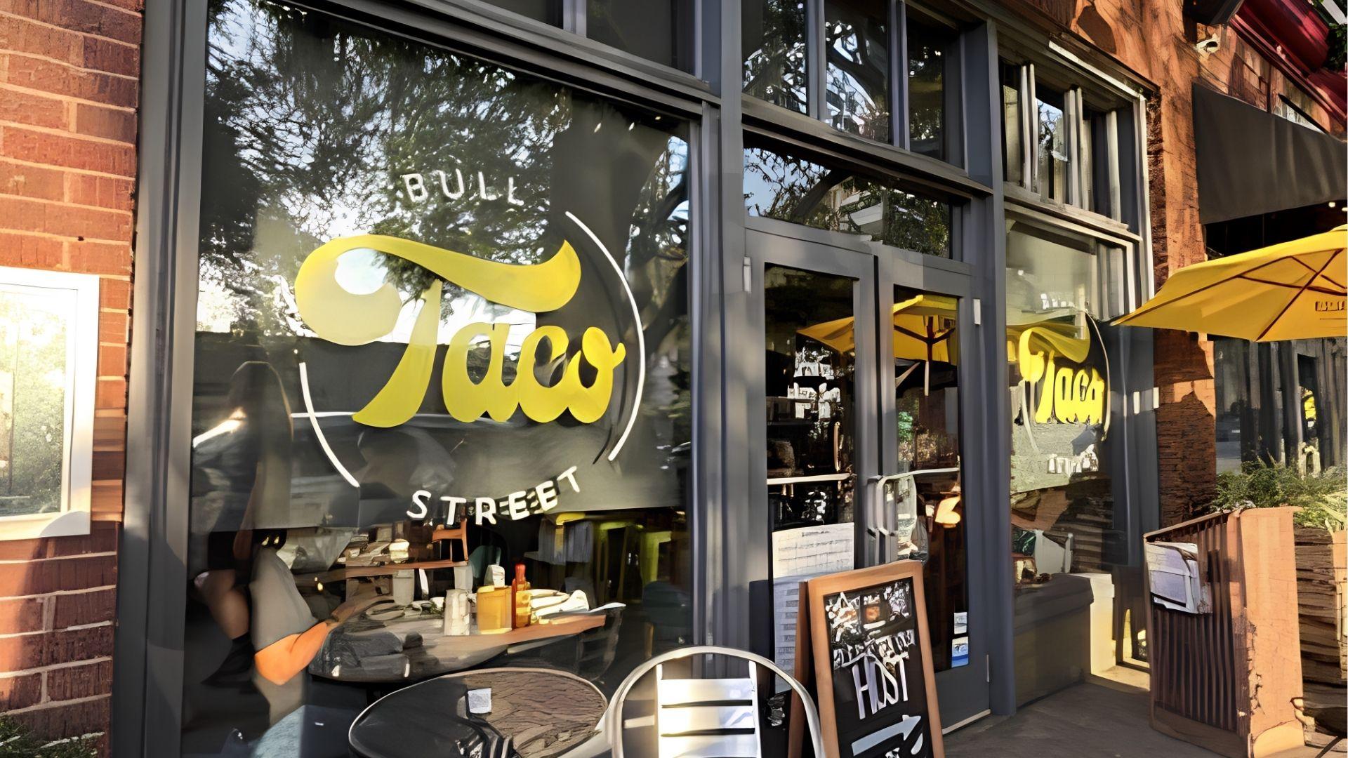 Bull Street Taco exterior in brick wall designs and black matte panels and glass windows.