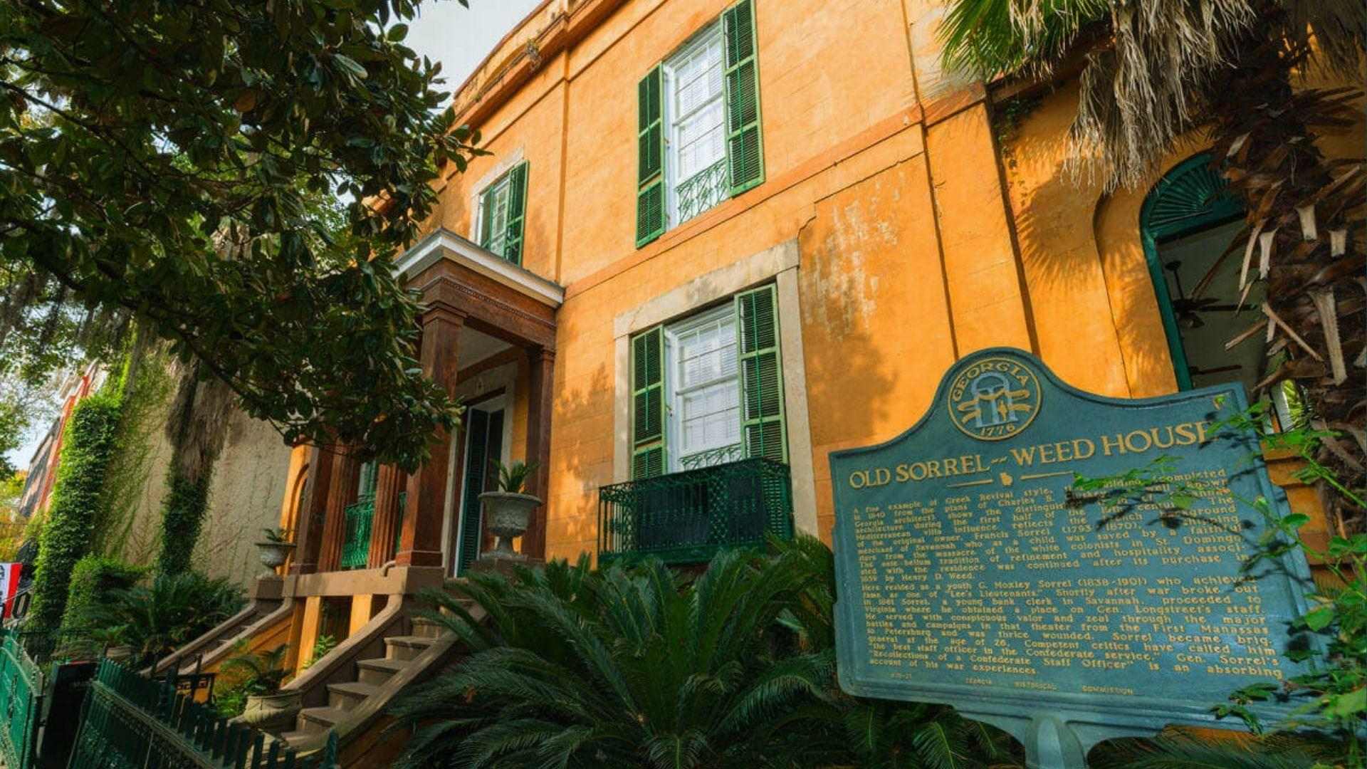 Old Sorrel-Weed House orange stucco with green shutters and Georgia historic marker sign