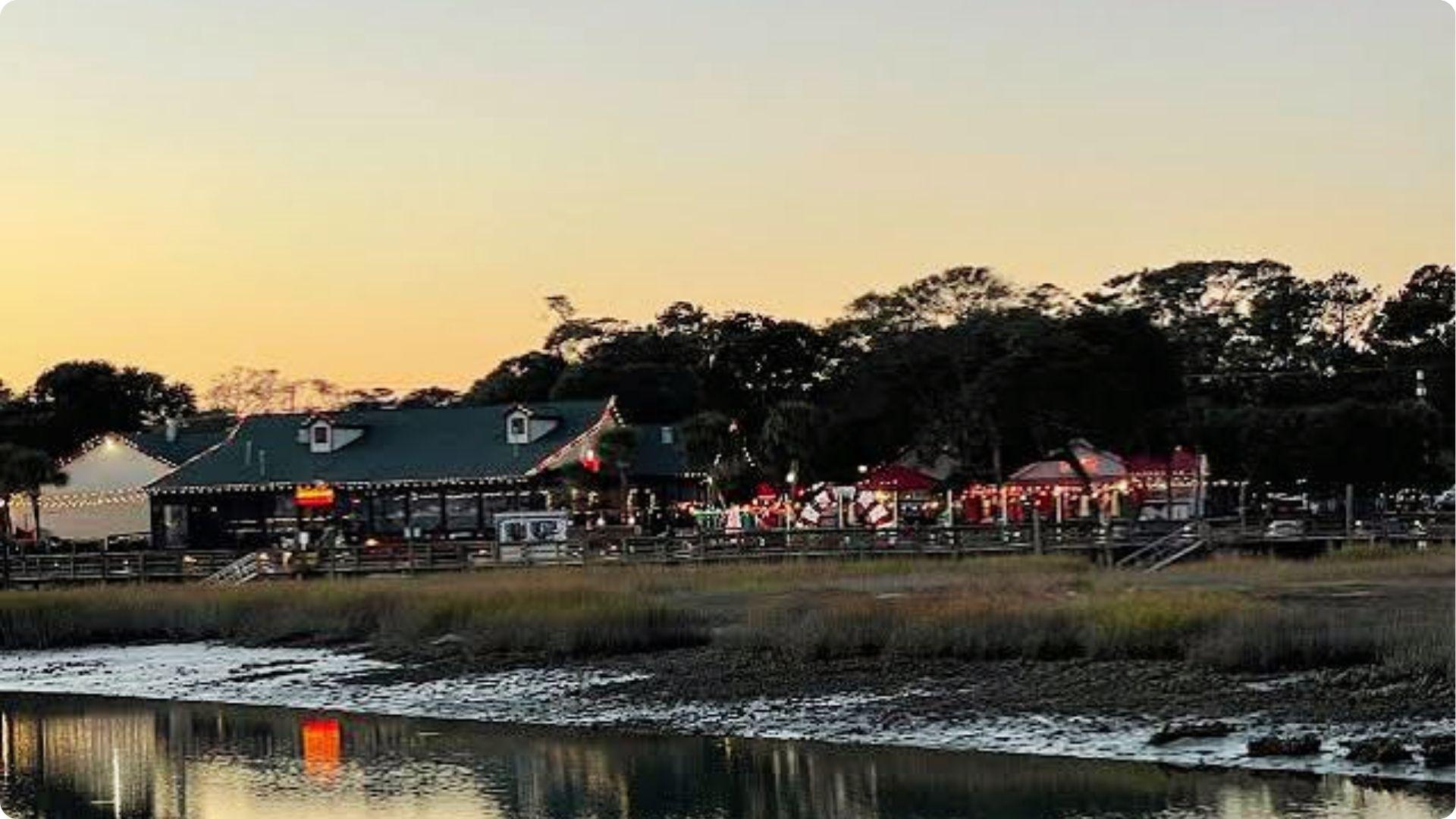 Couple enjoying romantic waterfront dining at marshfront restaurant at sunset in Myrtle Beach SC