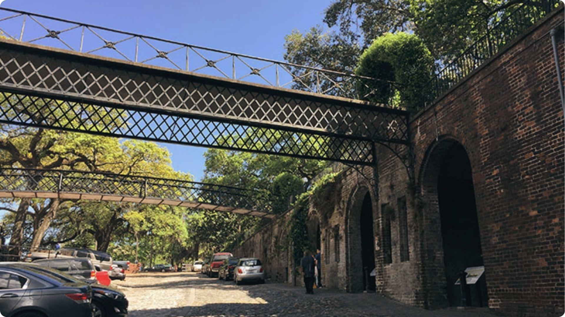 Historic iron pedestrian bridges over Factors Walk cobblestones, highlight on Savannah walking tour map