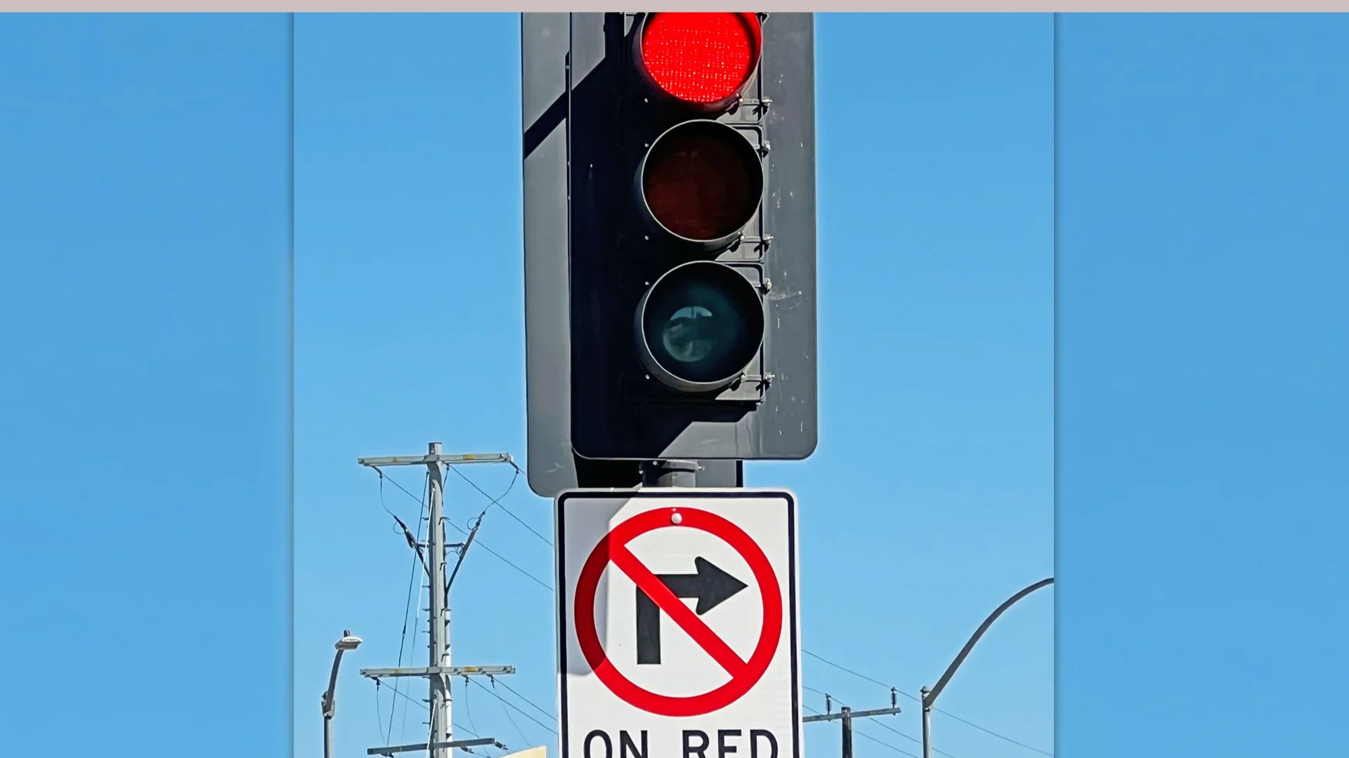 Red traffic light with No Right Turn On Red regulatory sign below