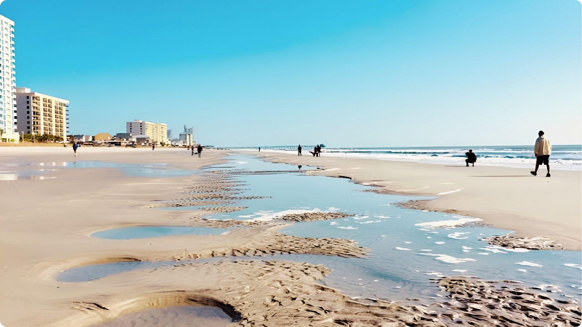Sandy Myrtle Beach shoreline at low tide with hotels and pier, romantic stroll for couples