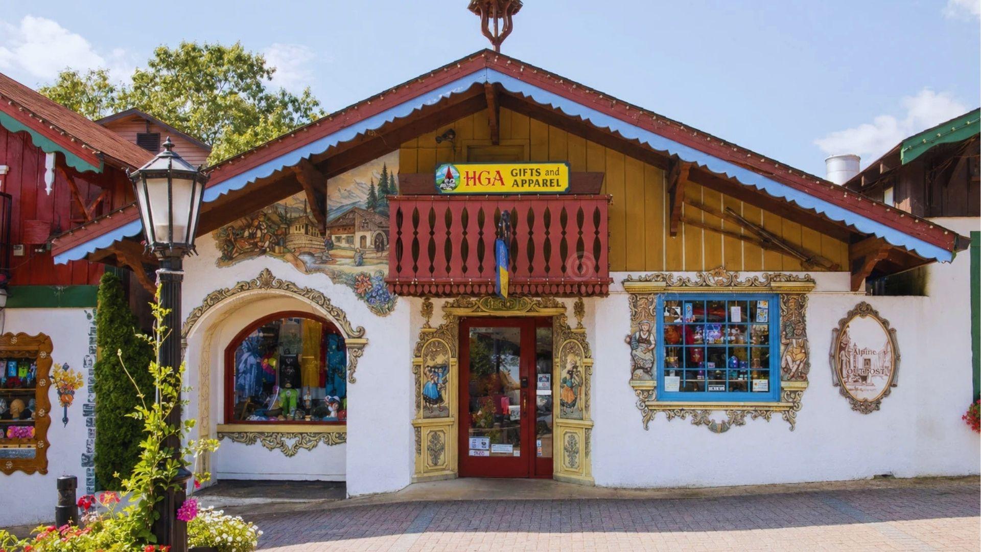 Bavarian gift shop facade labeled HGA Gifts and Apparel with ornate trim and flower decorations.