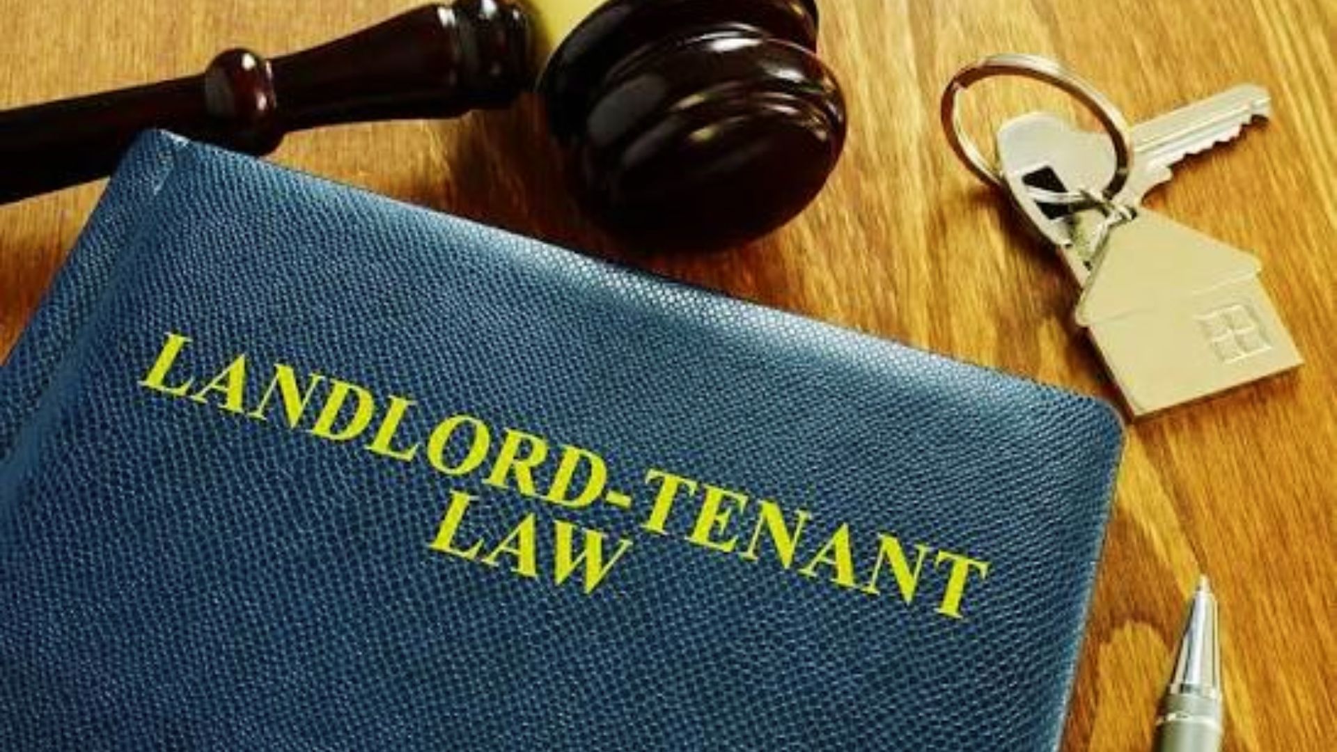 Landlord-tenant law book with gavel and house keys showing Georgia rental regulations