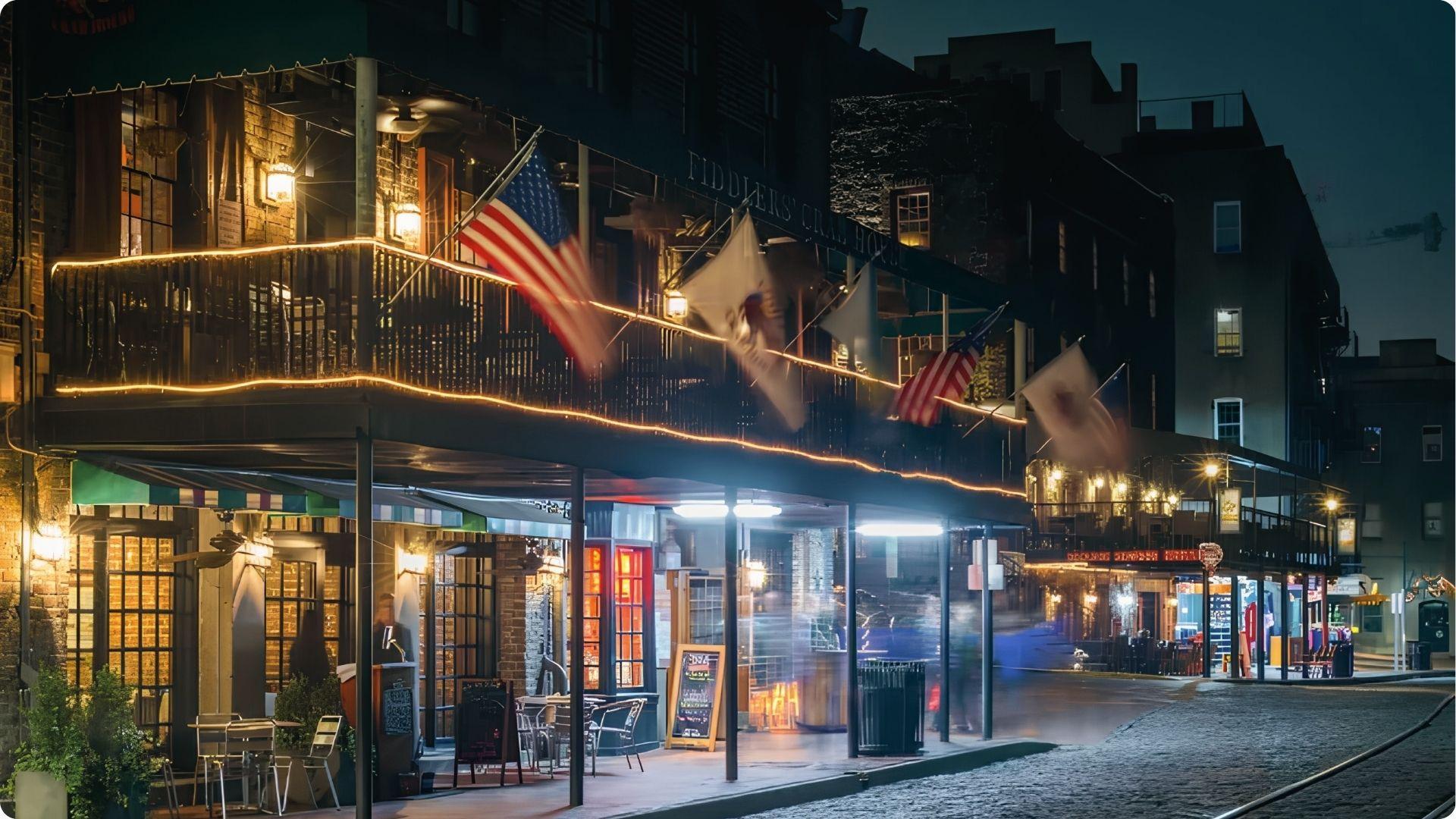 Savannah Riverfront promenade with flags and market tents along waterfront walking tour path.