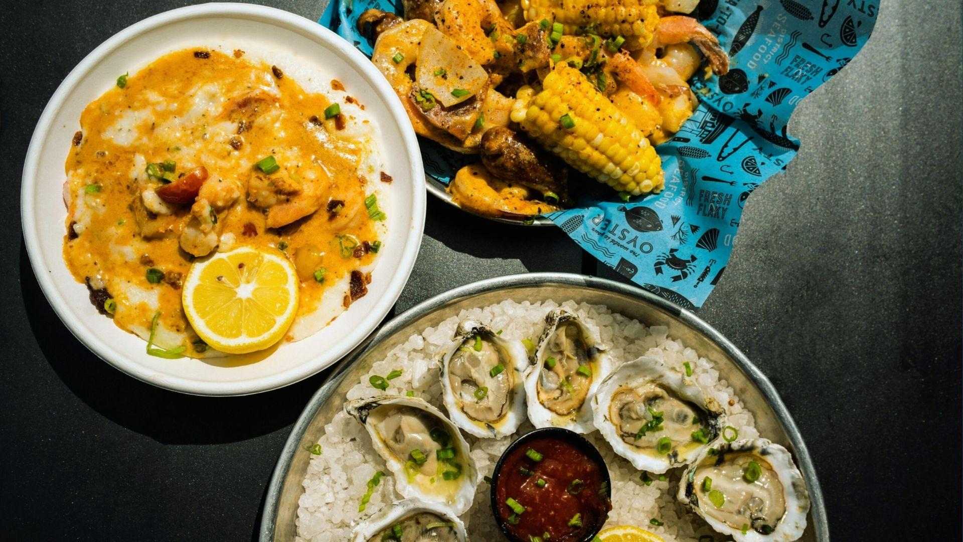 Shrimp and grits, shrimp boil with corn, and oysters on ice with cocktail sauce
