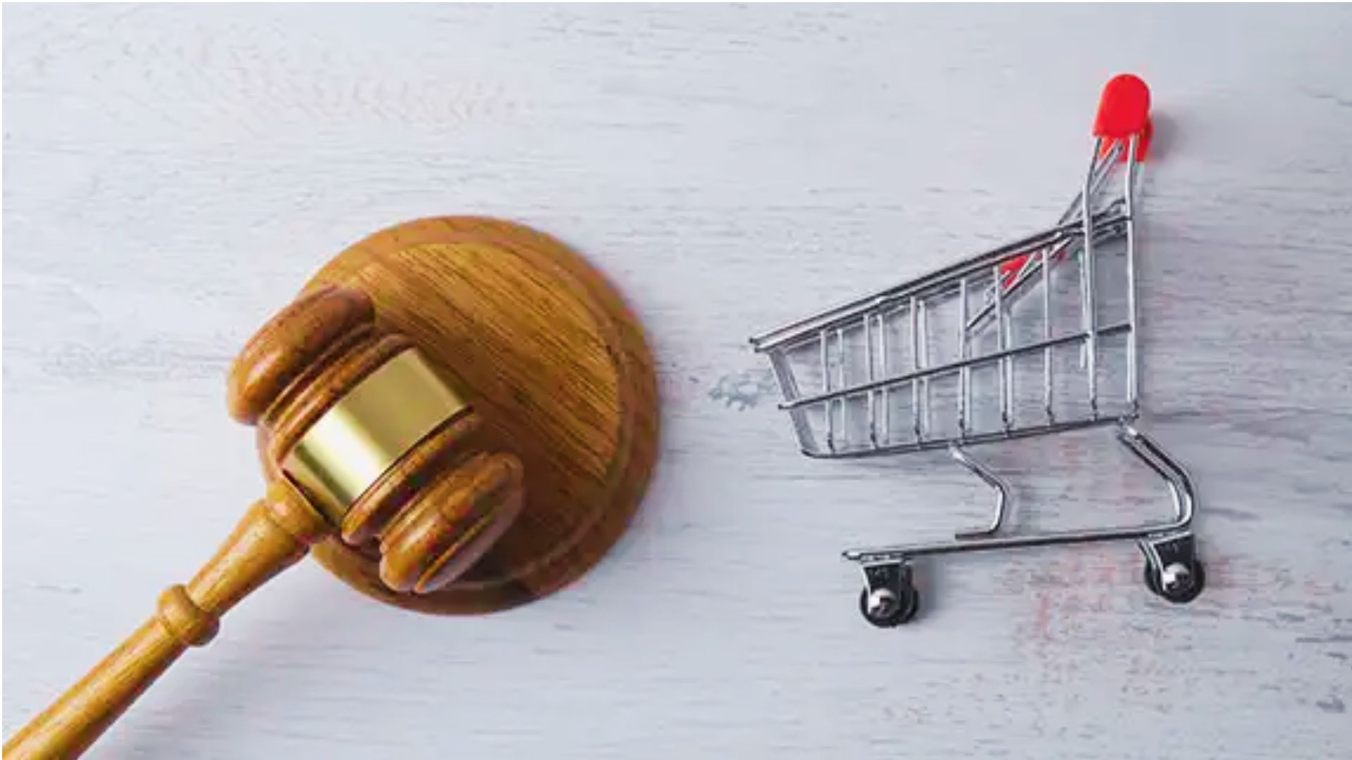 Judge gavel beside shopping cart representing consumer protection under Georgia Lemon Law