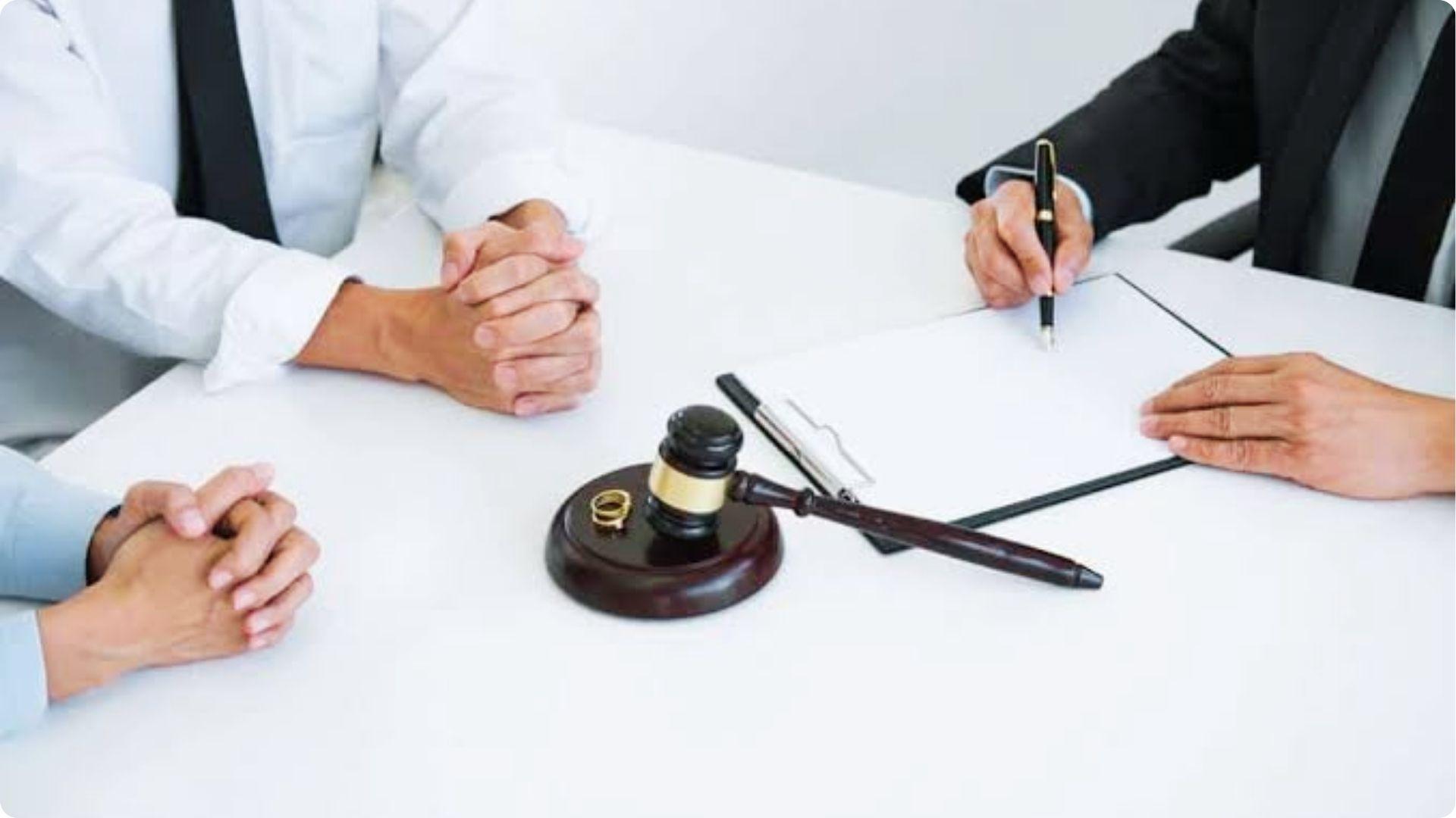 Divorce lawyers meeting at desk with gavel and rings discussing Georgia common law marriage status