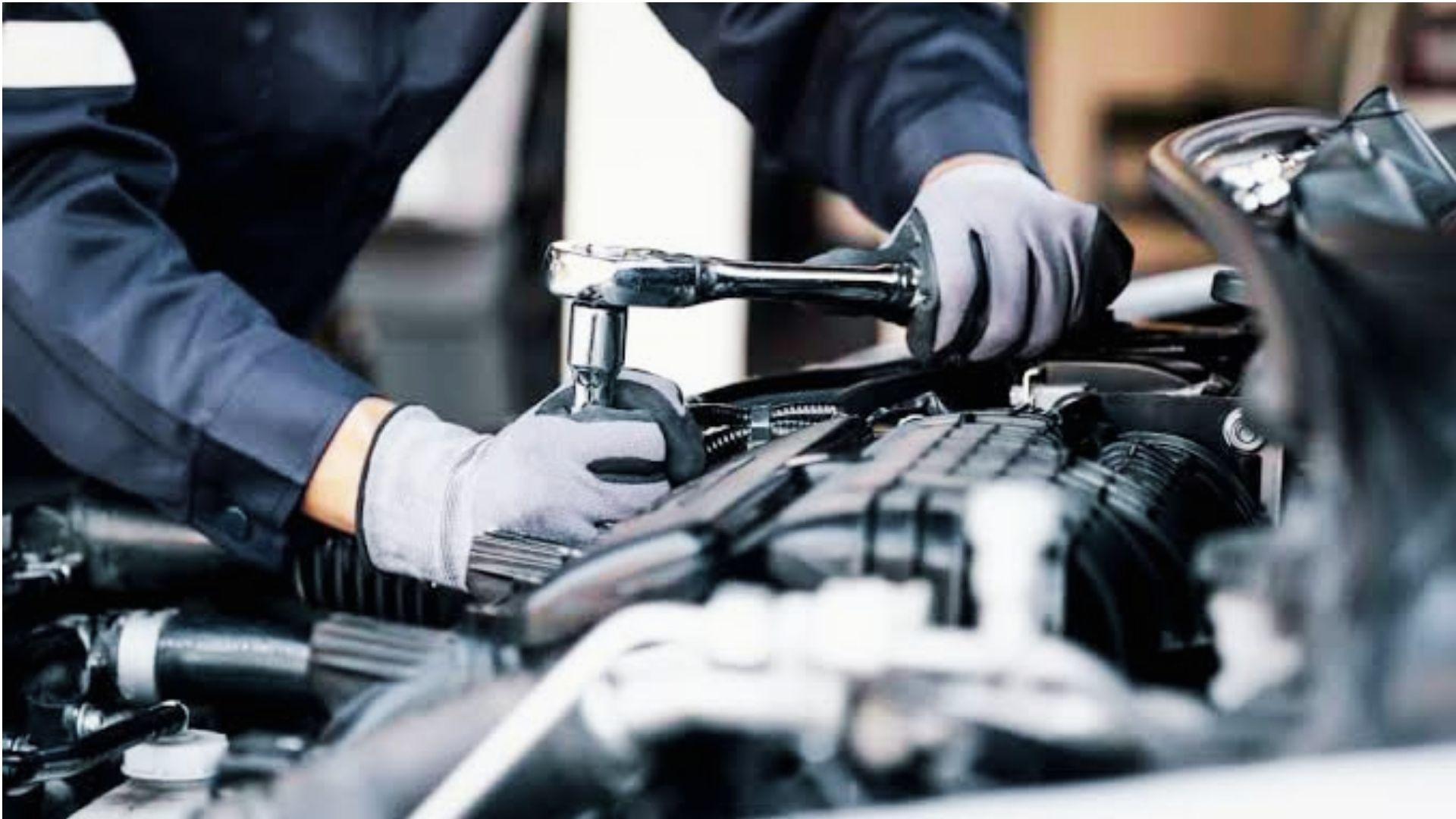 Mechanic repairing car engine after repeated failures under Georgia Lemon Law
