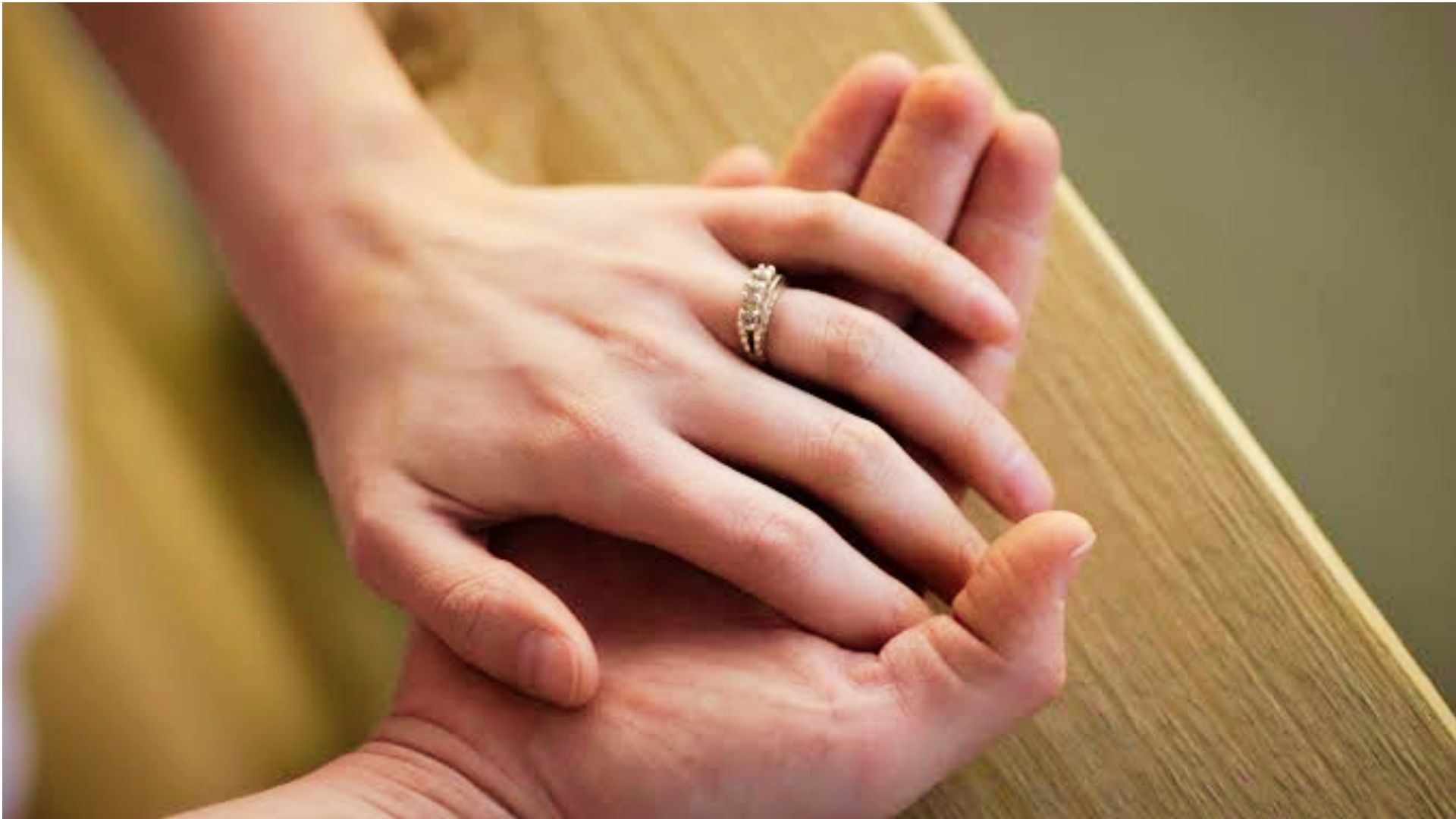 Couple holding hands with wedding ring showing marriage commitment in Georgia