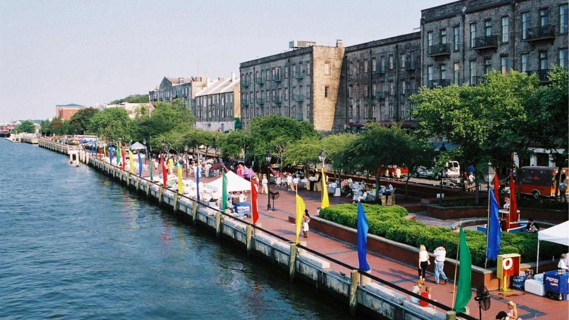 Savannah River Street waterfront with colorful flags during October festival